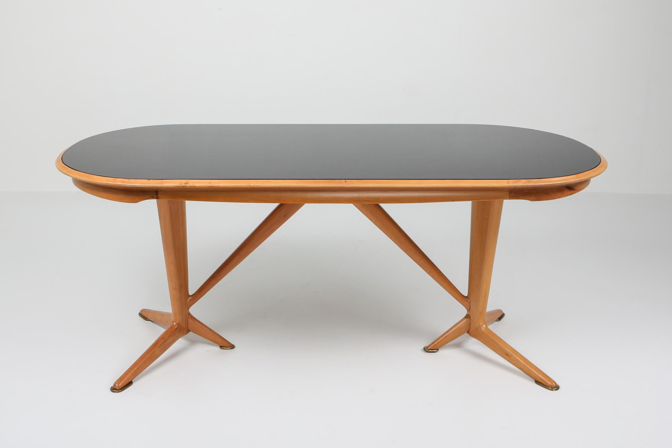 Oak dining table with smoked glass top in the manner of Gio Ponti, Italy, 1970s. Check out the Goldwood storefront for more available pieces.