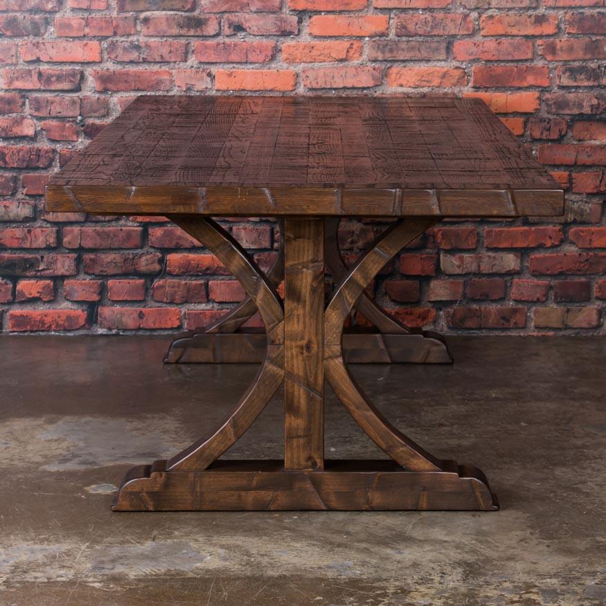 This impressive 8' long dining table was custom-made using old reclaimed oak boxcar flooring. The distressed wood is a result of years of moving cargo through the train’s boxcars resulting in a modern dark, rich dining surface. It has been sanded,