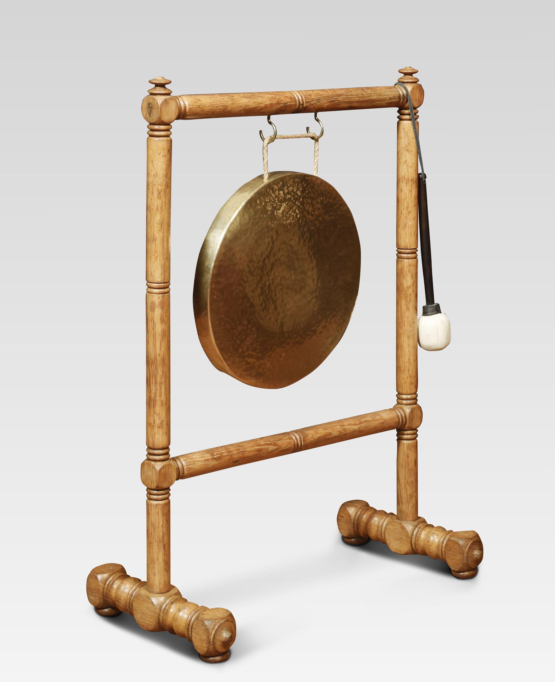 Oak framed brass dinner gong and beater, the stand having turned upright supports suspending the original brass gong to centre raised up on platform base.
Dimensions
Height 37 Inches
Width 26.5 Inches
Depth 14 Inches