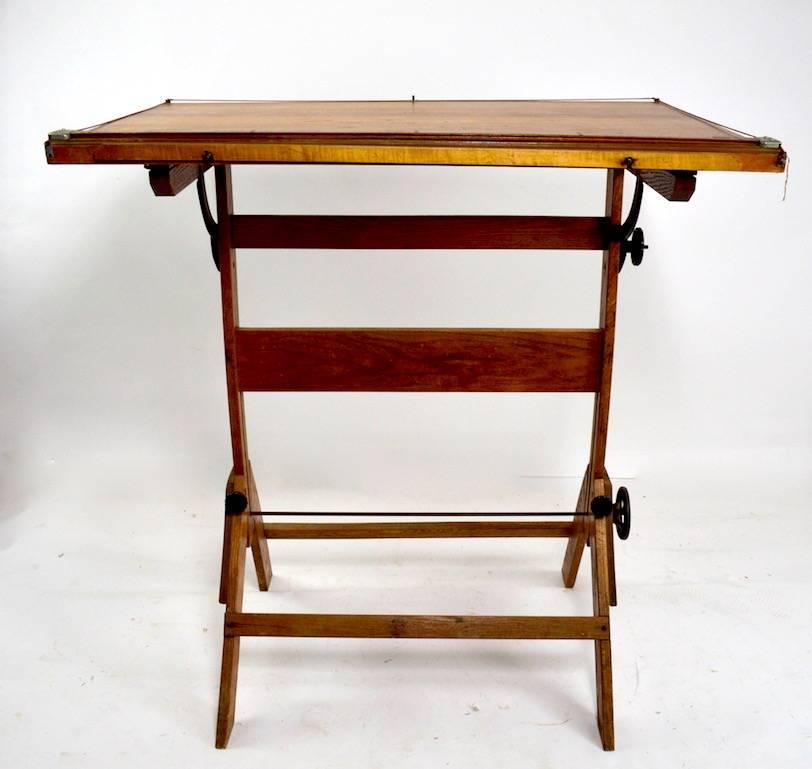 Great oak drafting table, with multiple adjustments including tilt top, and height (Lowest H 33 inches, highest H 44.5 inches) Nice, clean, and original condition.