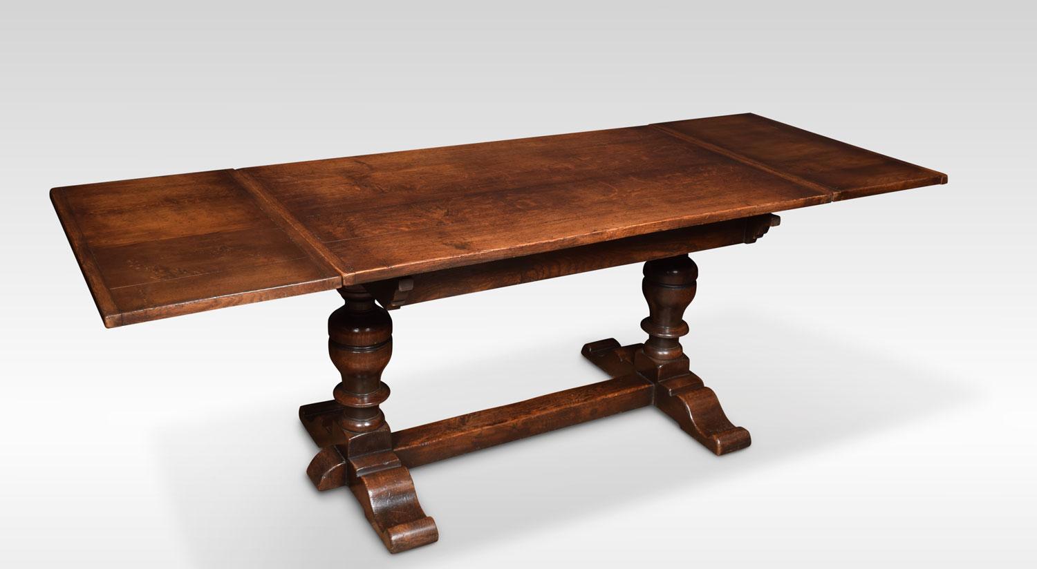 Oak draw leaf refectory table, the rectangular solid oak top having pull-out ends. Above lobed carved bulbous supports united by a stretcher.
Dimensions:
Height 31 inches
Width 54 inches opening to 90 inches
Depth 32.5 inches.