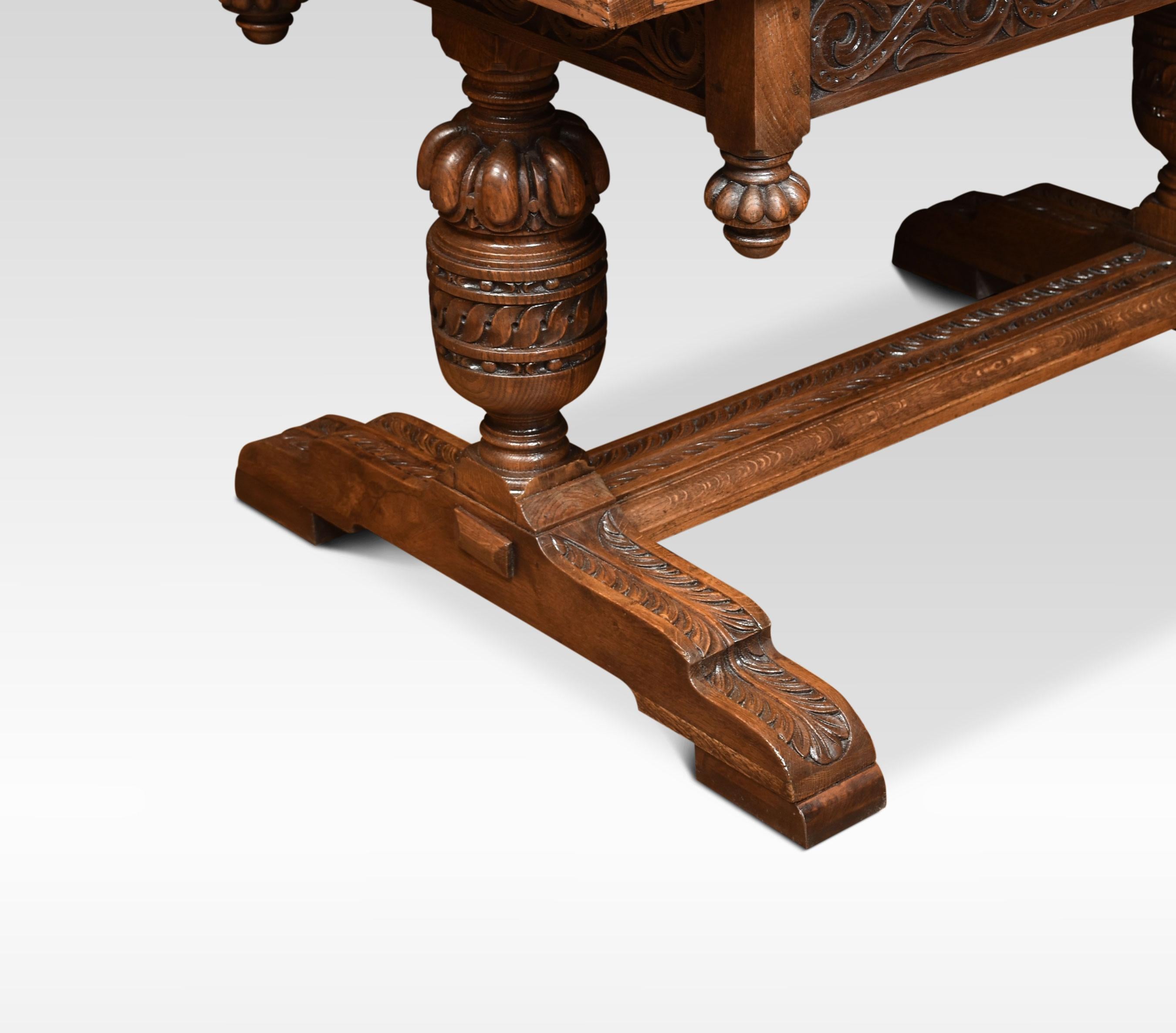 Oak draw-leaf table of generous proportions. The thick plank top having pull-out leaves to each end above a strap-work frieze with scrolling carving. Raised up on bulbous cup & cover legs leading down to block feet united by