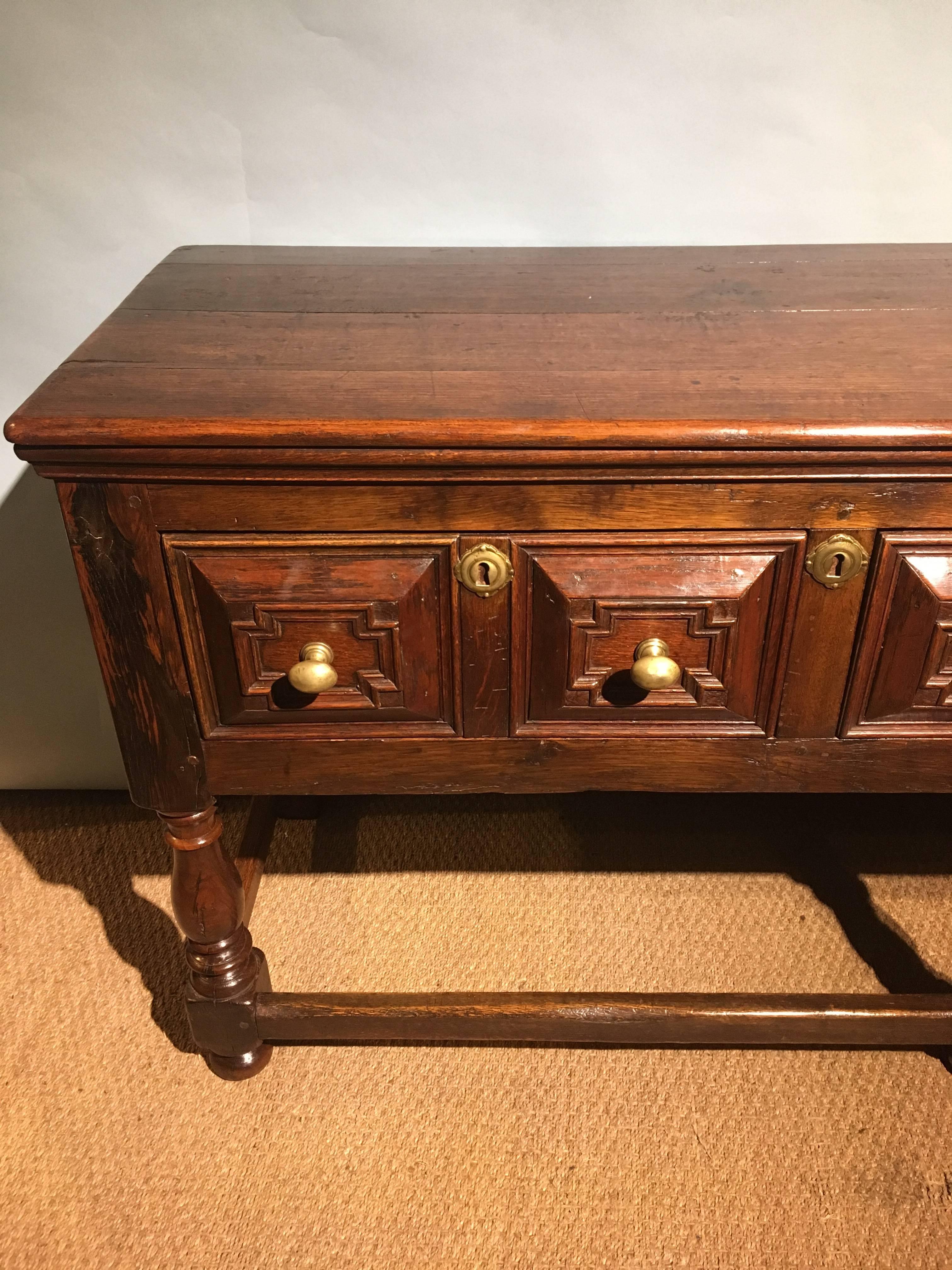 Good quality late 19th century oak dresser base 

English dating to circa 1890s having three large drawers and brass fittings. 

This piece has been through our workshops cleaned polished and has a lovely color / patina.

Measures: Height 31