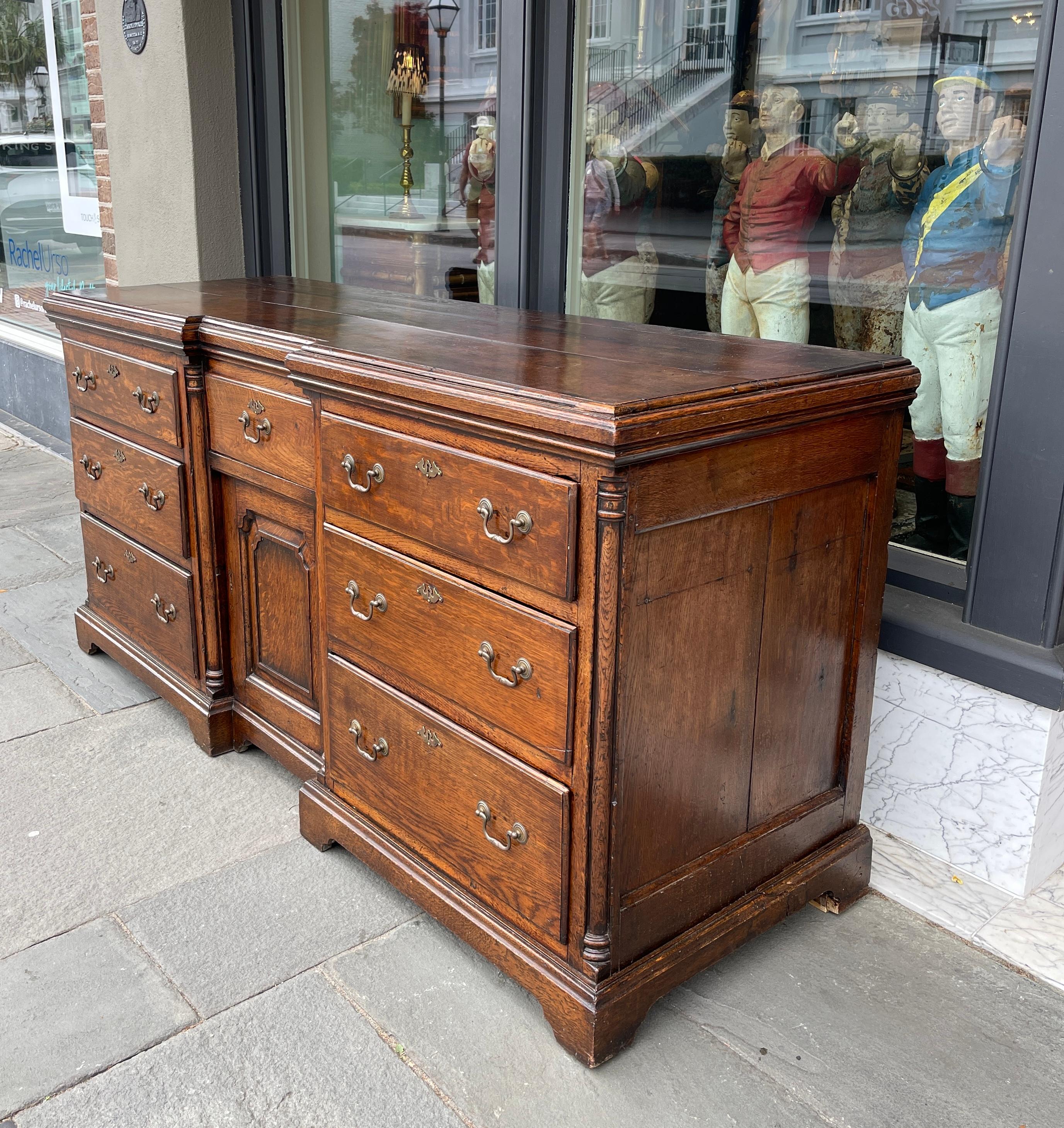 Lovely oak dresser base with 6 side drawers and center drawer over open cabinet.