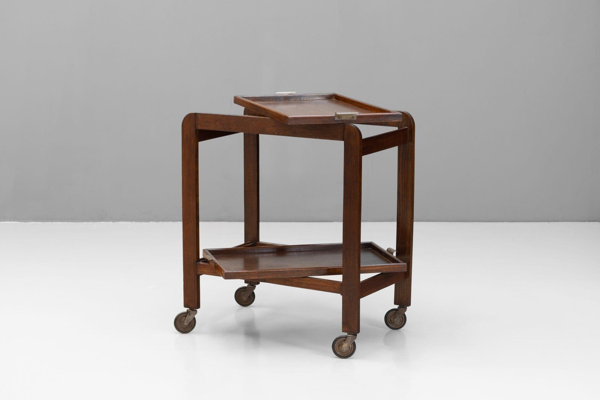 Solid oak drinks trolley in an Art Deco style. Removable serving trays. U.K circa 1950.

H 77cm x W 44cm x D 67cm