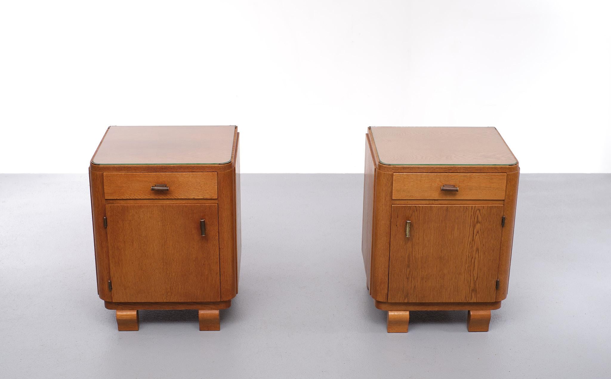 Two very nice Dutch Art Deco night stands. Oak wood, comes with Brass 
handles. New glass plates on top .to protect the wood. These pieces are 
A perfect example off the Amsterdamse School style. 1920/30.