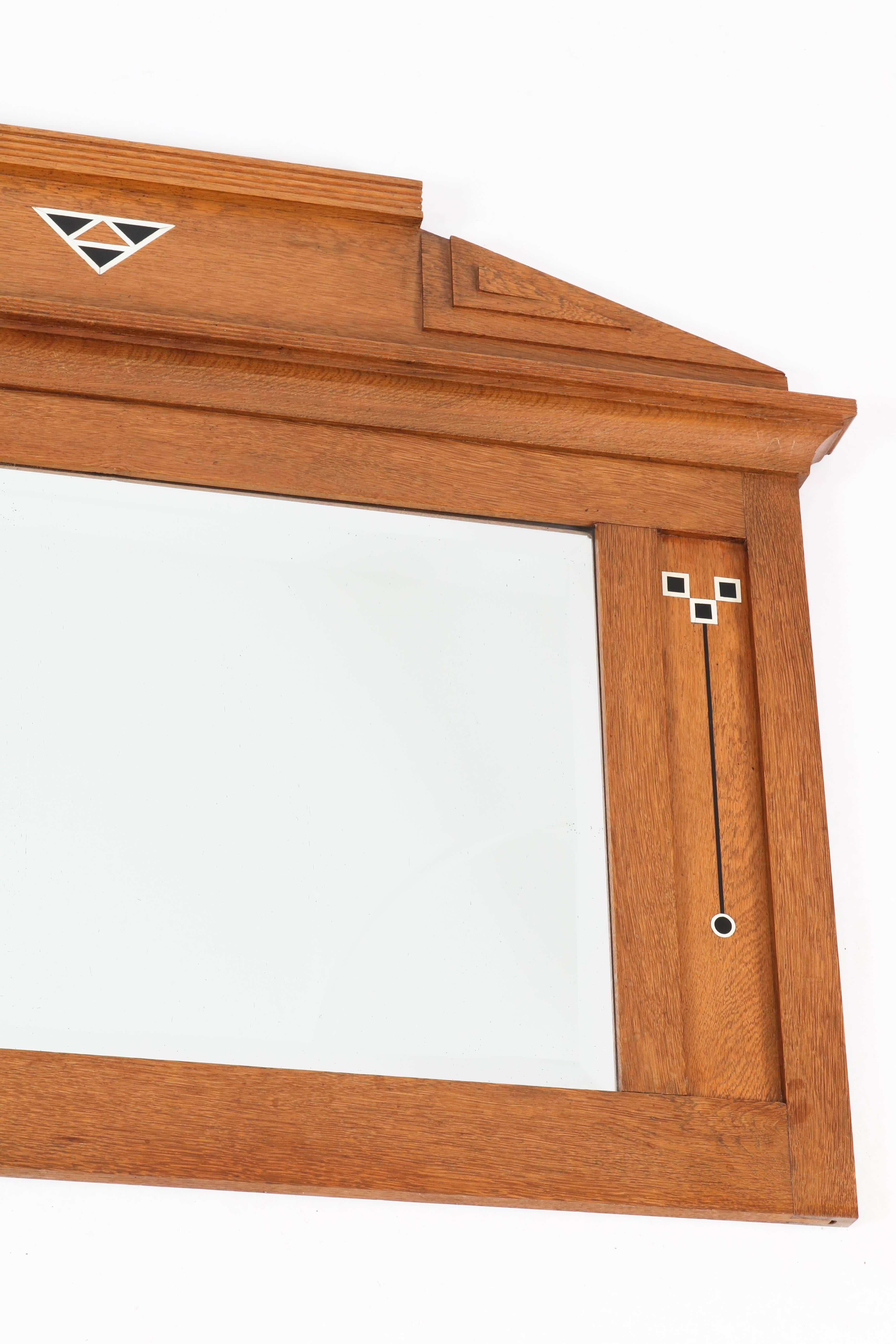Dutch Art Nouveau mirror with inlay.
Solid oak with original beveled glass.
In good original condition with minor wear consistent with age and use,
preserving a beautiful patina.