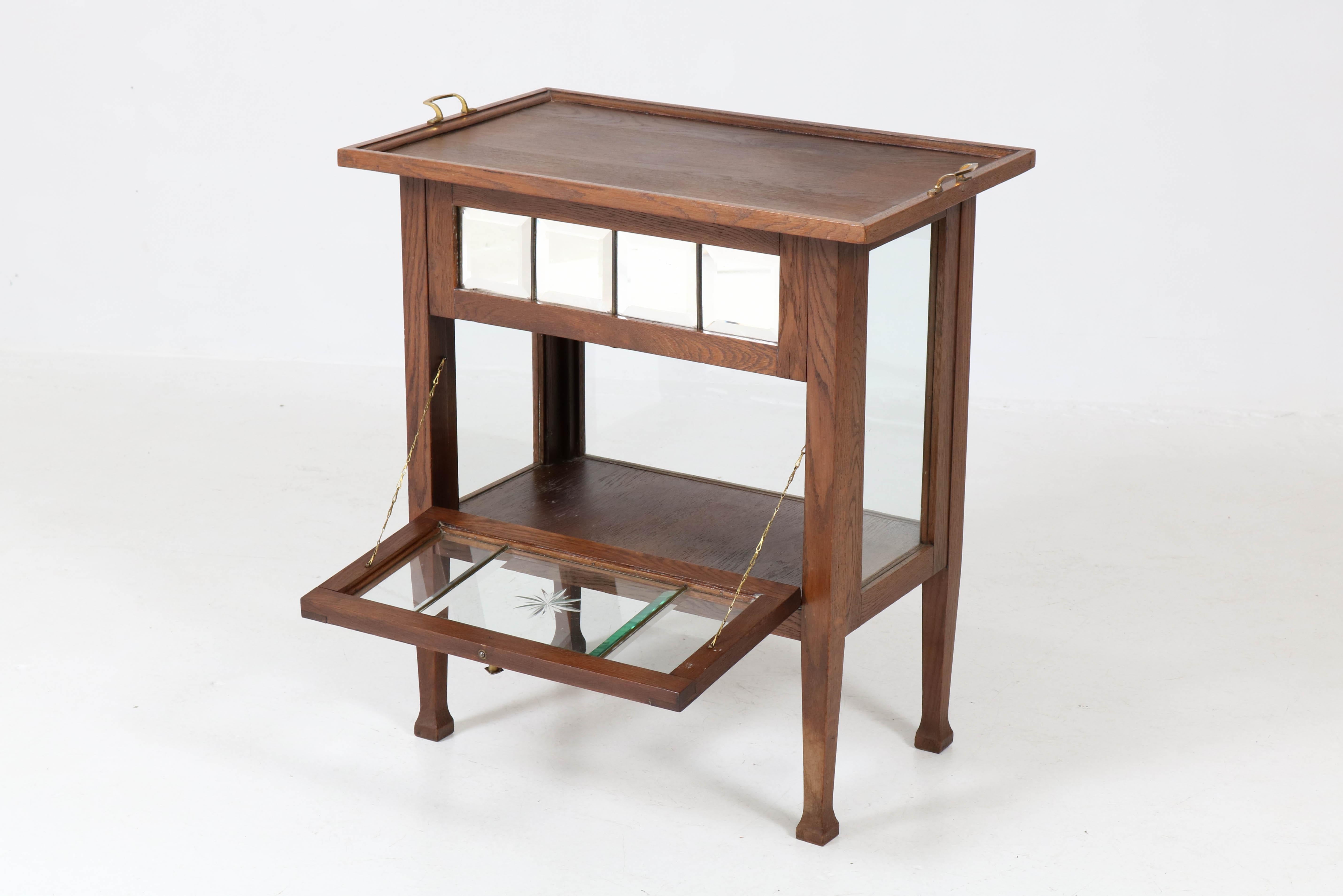 Elegant and rare tea cabinet with original tray, 1900s.
Solid oak and the door has original beveled glass.
In good original condition with minor wear consistent with age and use,
preserving a beautiful patina.