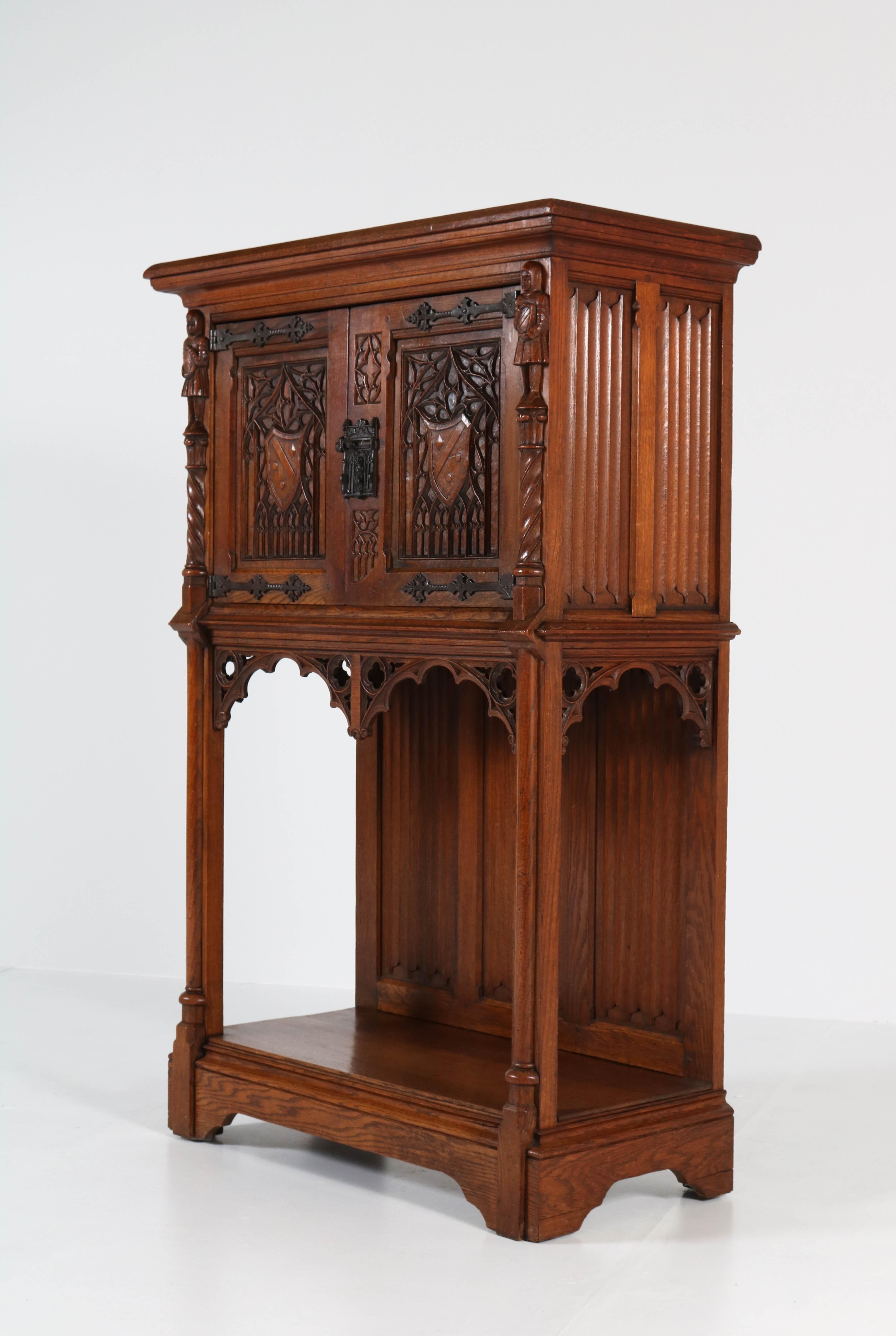 Offered by Amsterdam Modernism:
Dutch Neo Gothic cabinet with carved knights, 1930s.
Solid oak with original lock.
In good original condition with minor wear consistent with age and use,
preserving a beautiful patina.