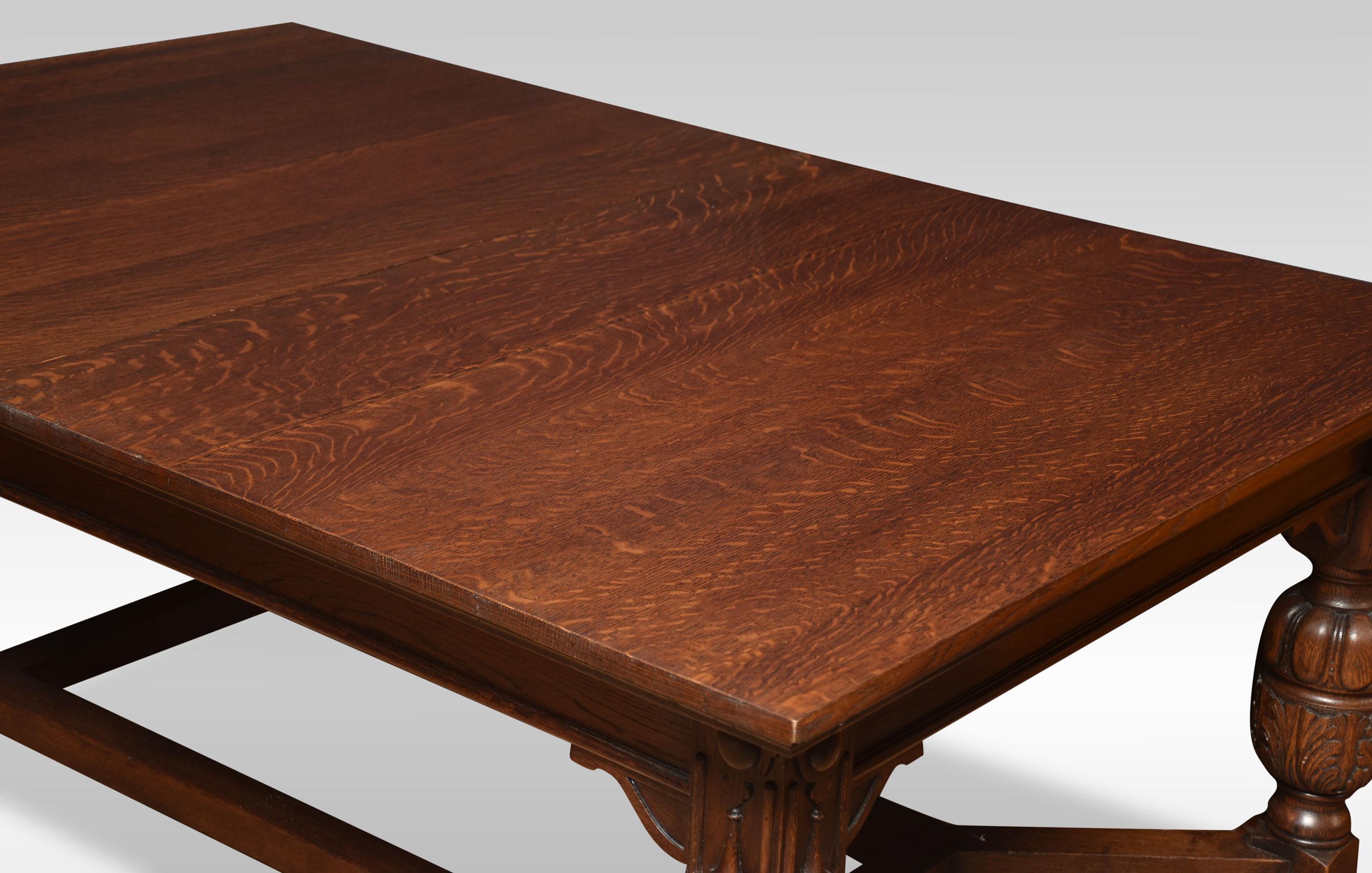 Oak dining table of generous proportions. The well-figured top has pull-out ends to incorporate two original oak leaves. To the moulded freeze raised up on cup & cover legs leading down to bun feet united by stretchers.
Dimensions:
Height: 30