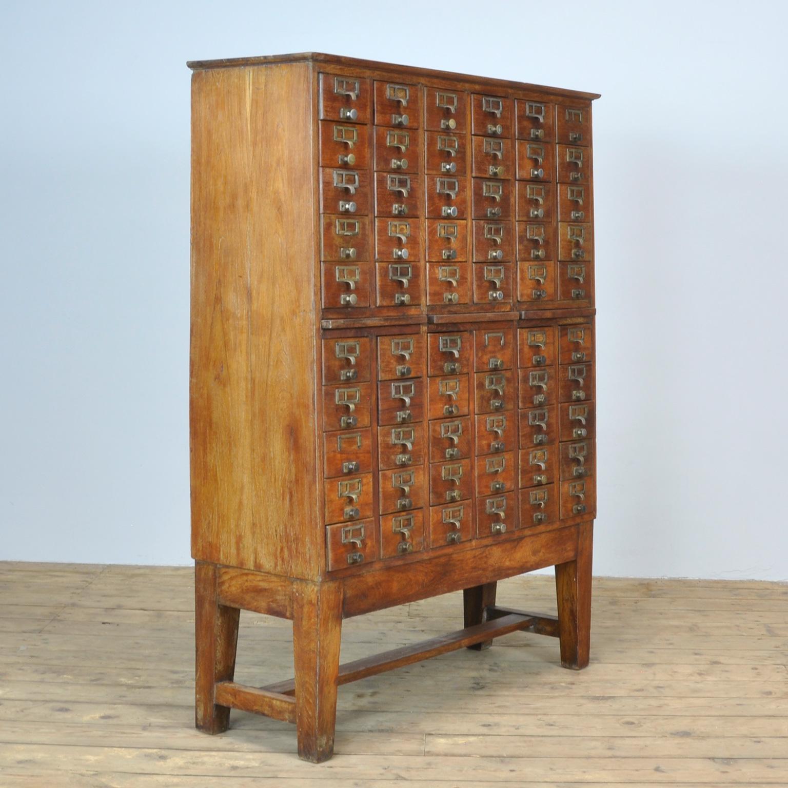 Oak filing cabinet from the 1940s. With 60 drawers with nice brass handles.