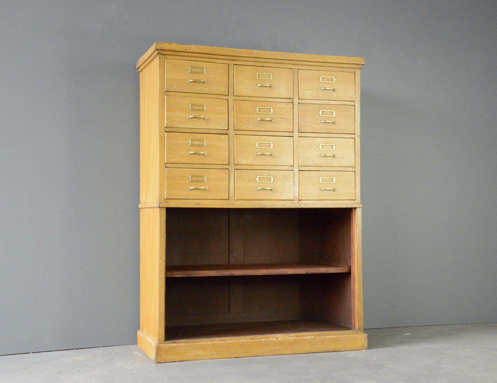 Oak Filing Drawers Circa 1930s

- Original wood grain effect finish
- 12 drawers
- 2 Shelves
- Original brass pull handles with label holders
- German ~ 1930s
- 133cm wide x 103cm tall x 51cm deep

Condition Report

Some chips to the wood grain
