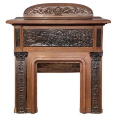 Camino in Oak con bassorilievi in gesso in finto bronzo, datato 1896