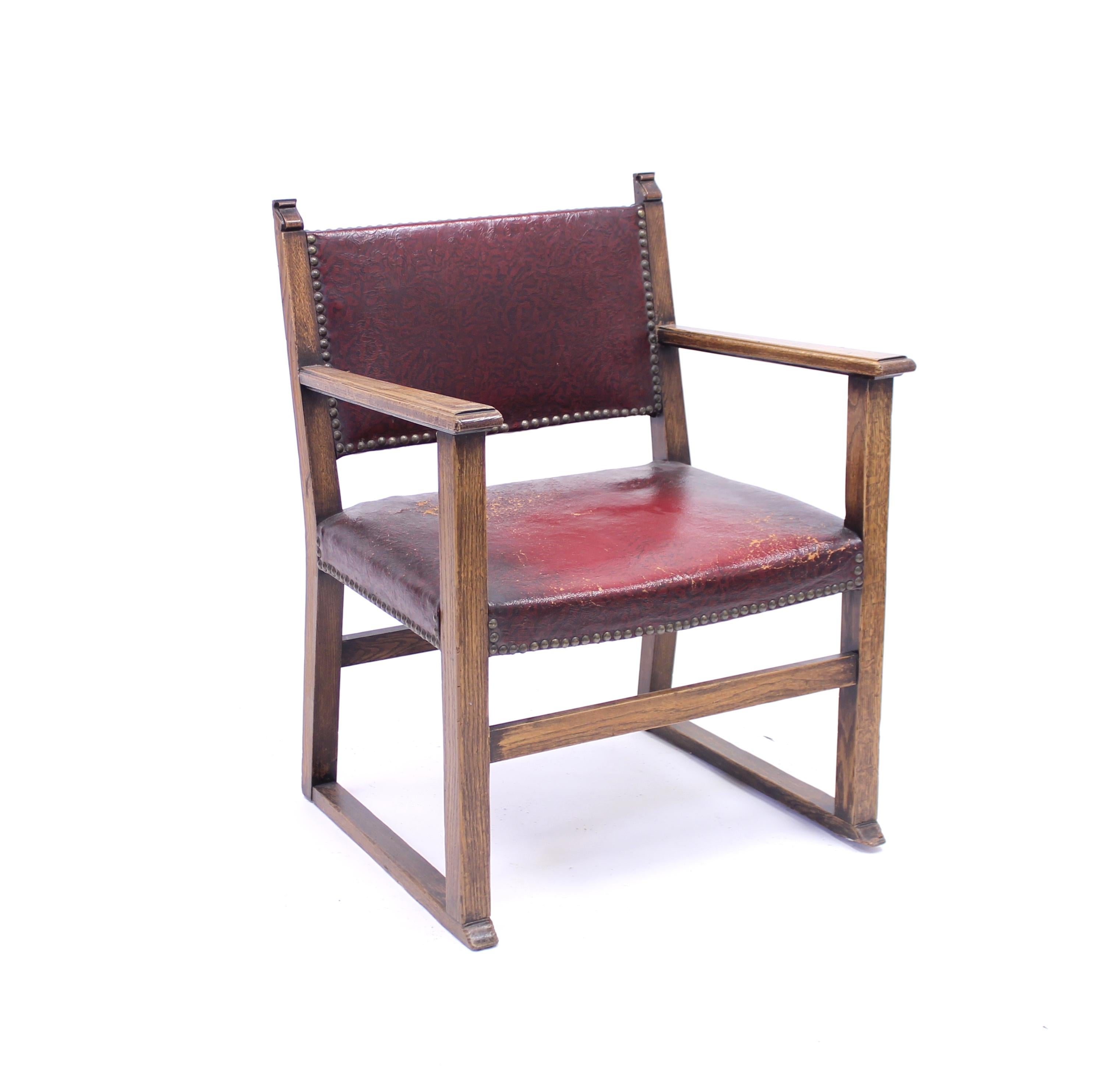 Fireside chair with a dark oak frame and red Naugahyde fabric from the 1930s, attributed to Austrian designer Adolf Loos. Adolf Loos used variants of this model in different interiors in both Czechia and Austria and the similar model he used is