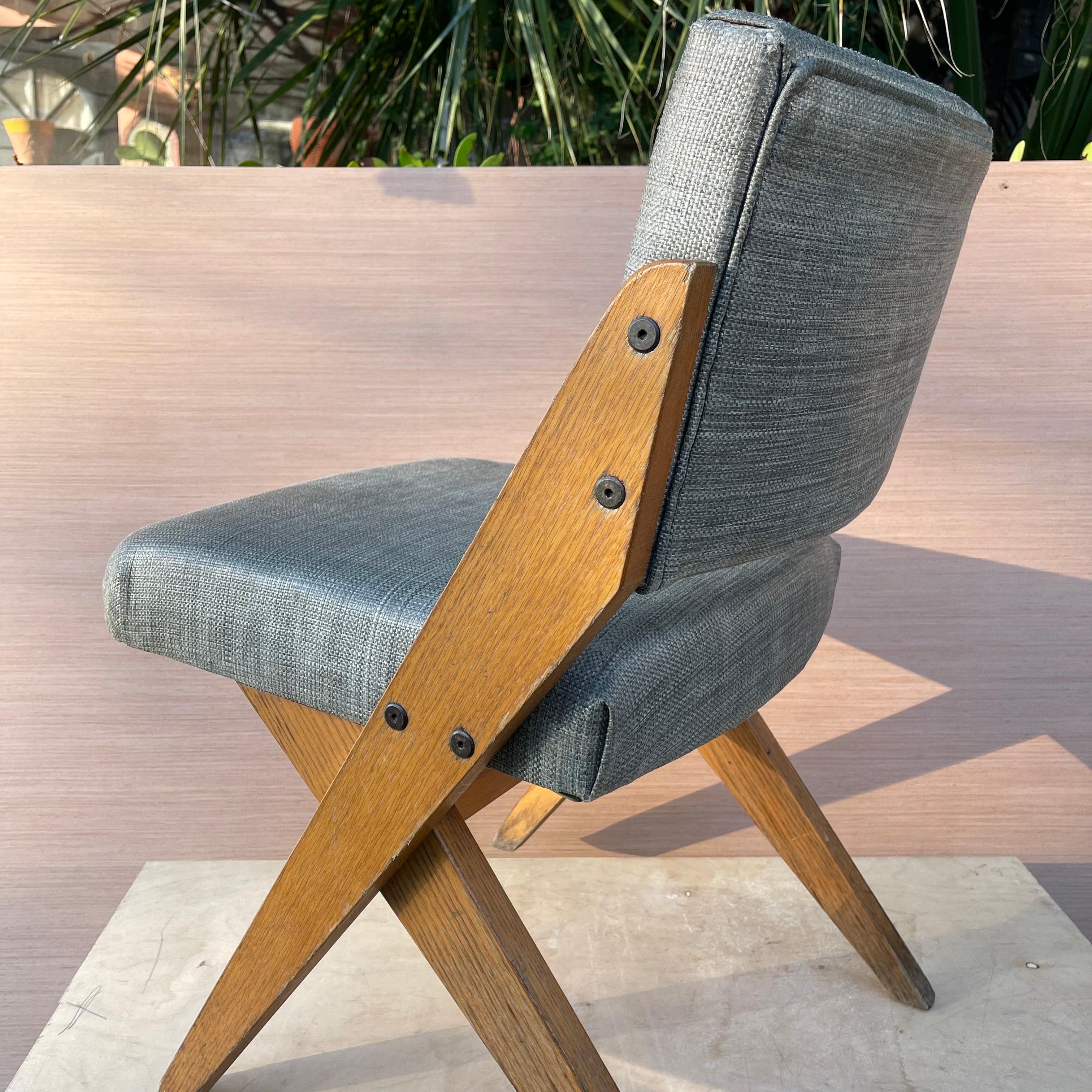 Oak frame scissor chair in the manner of Jose Zanine Caldas.

Multiple available, see photos for variation in color of upholstery. 