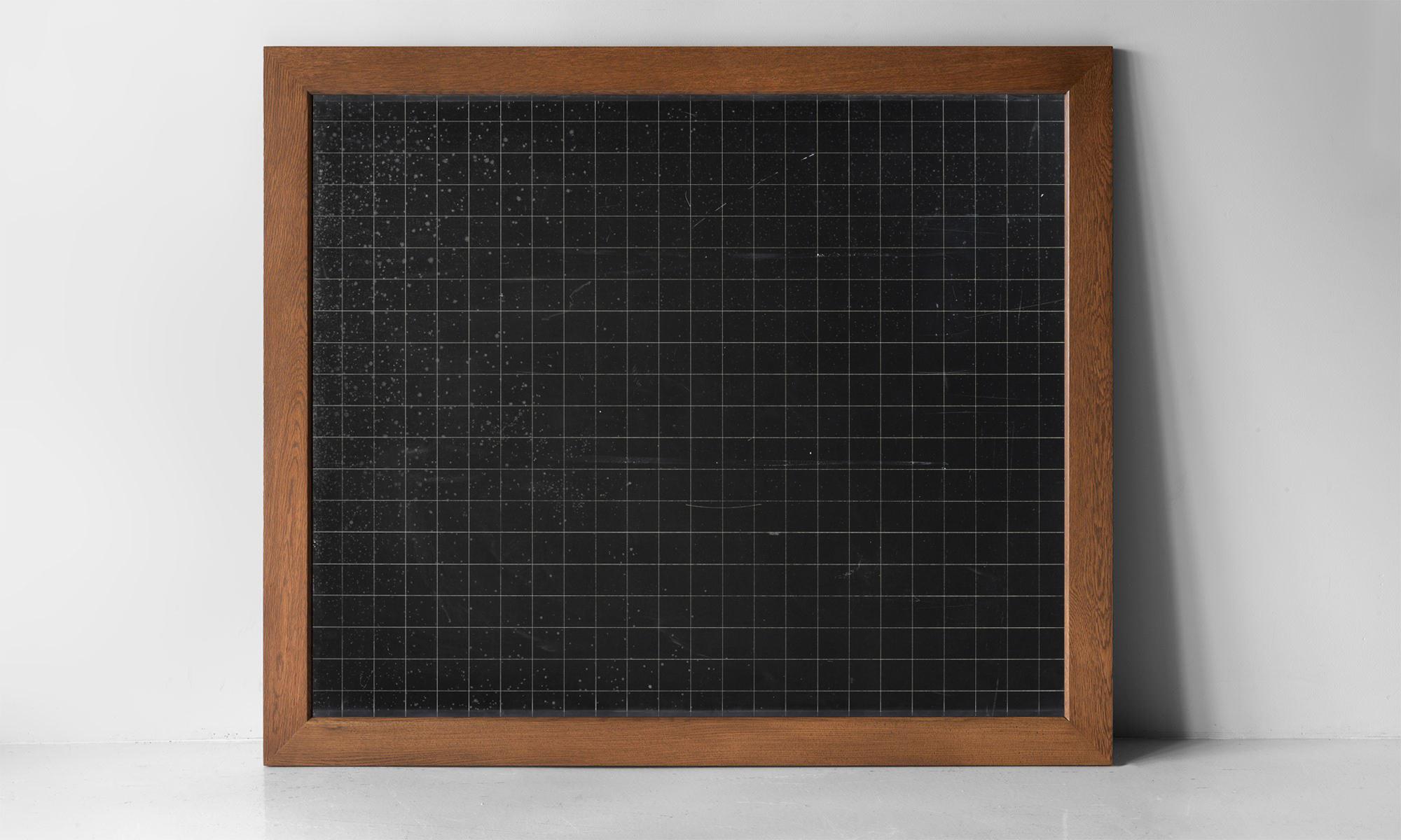 Oak framed slate chalkboard, England, circa 1920.

Blackboards made from single sheets of slate, engraved with a grid of lines.