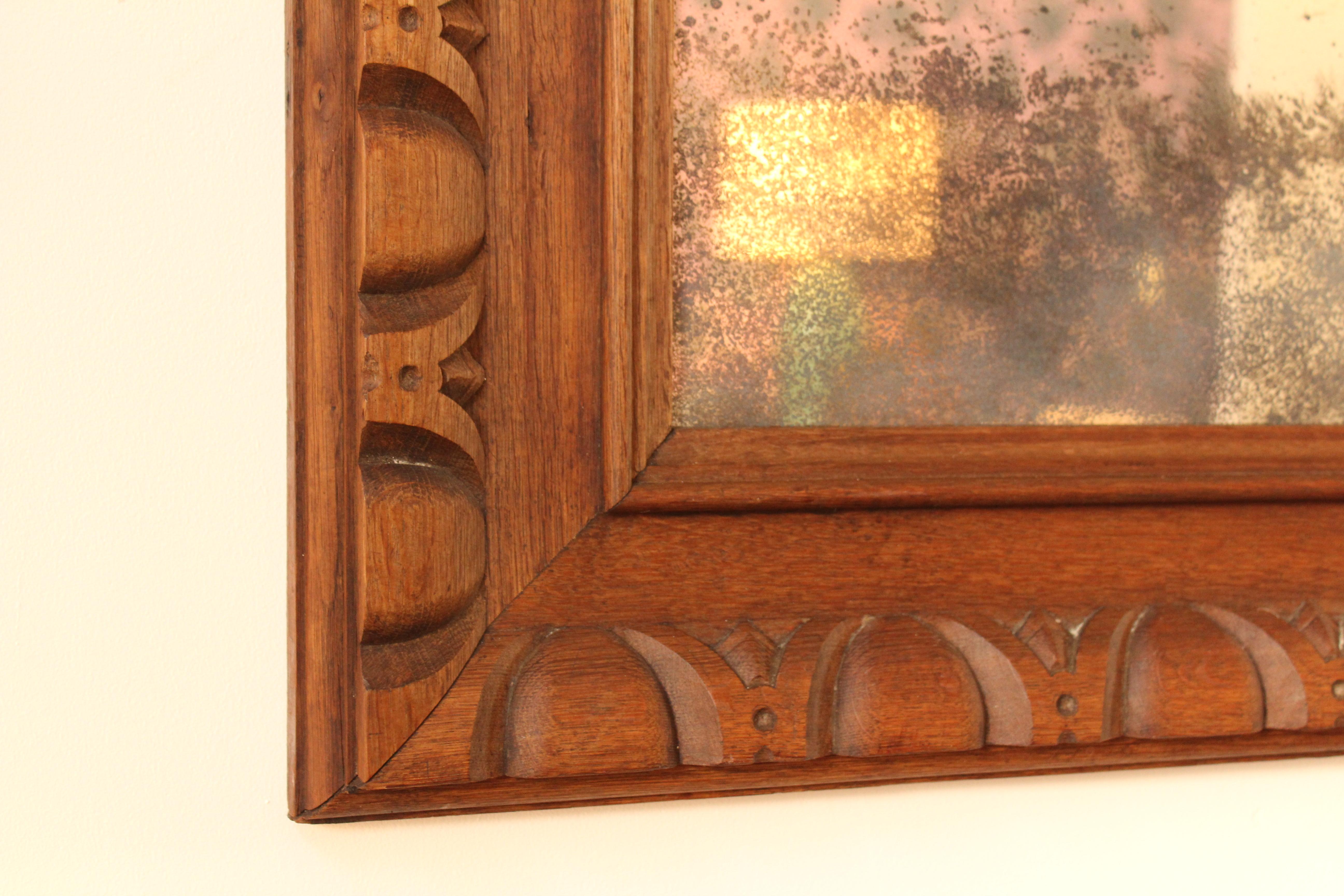 Large carved oak wall mirror, France, 1930s. The frame has been oiled and a mirror with an antique mercury finish has been professionally installed inside the frame.