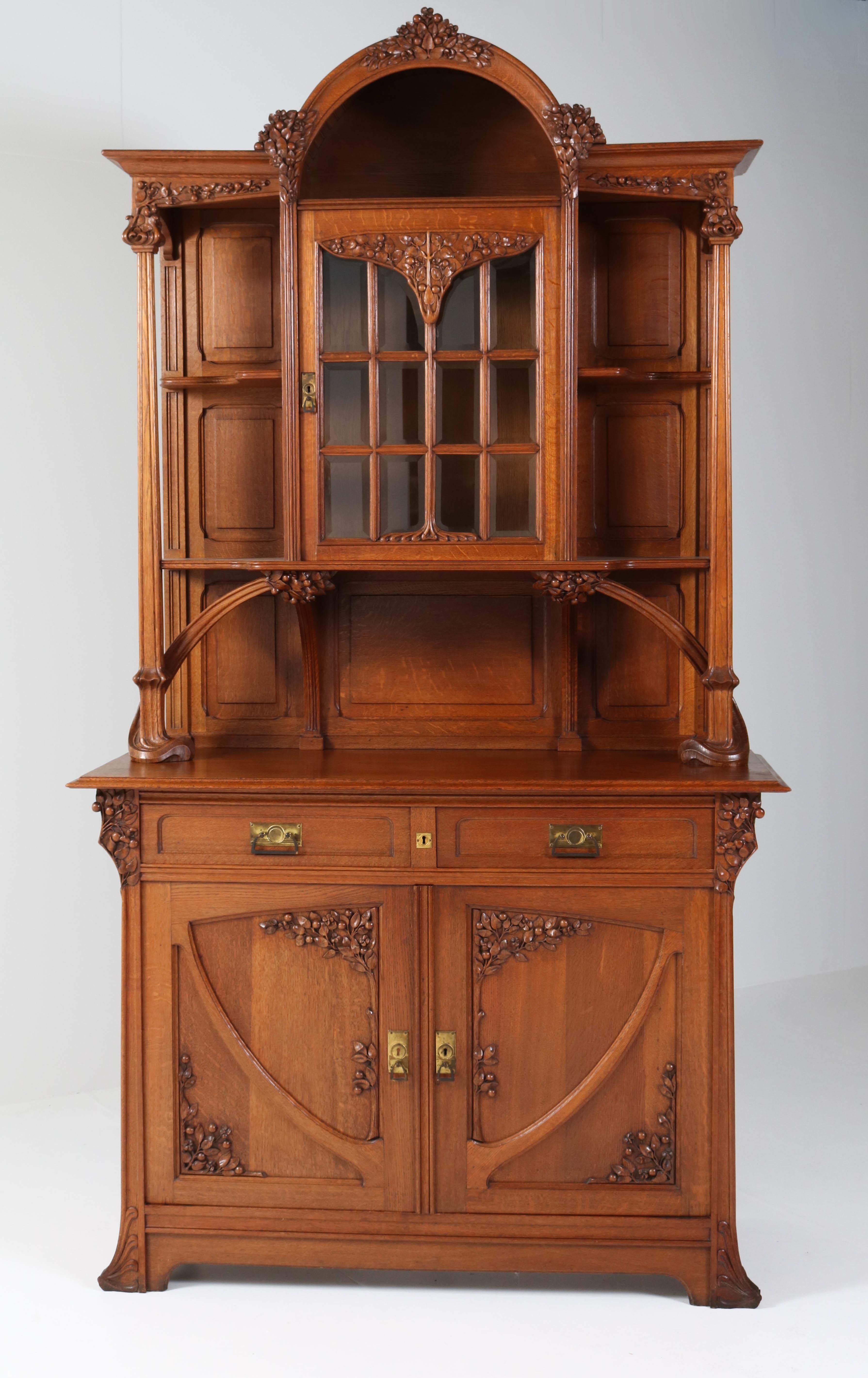 Wonderful top quality Art Nouveau buffet or cupboard.
Attributed to Jacques Gruber.
Striking French design from the 1900s.
Solid oak with amazing carved details.
Original beveled glass panels, one has a tiny crack, hard to see.
In good original