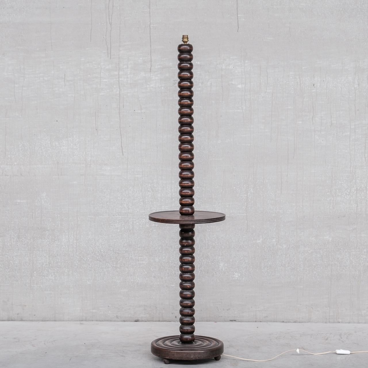 A stylish late deco floor lamp. 

France, c1940s. 

Turned oak in bobbin style. 

Integrated half height table. 

Since re-wired and PAT tested. 

Location: Belgium Gallery.

Dimensions: 145 H x 33 Diameter in cm. 

Delivery: POA

We