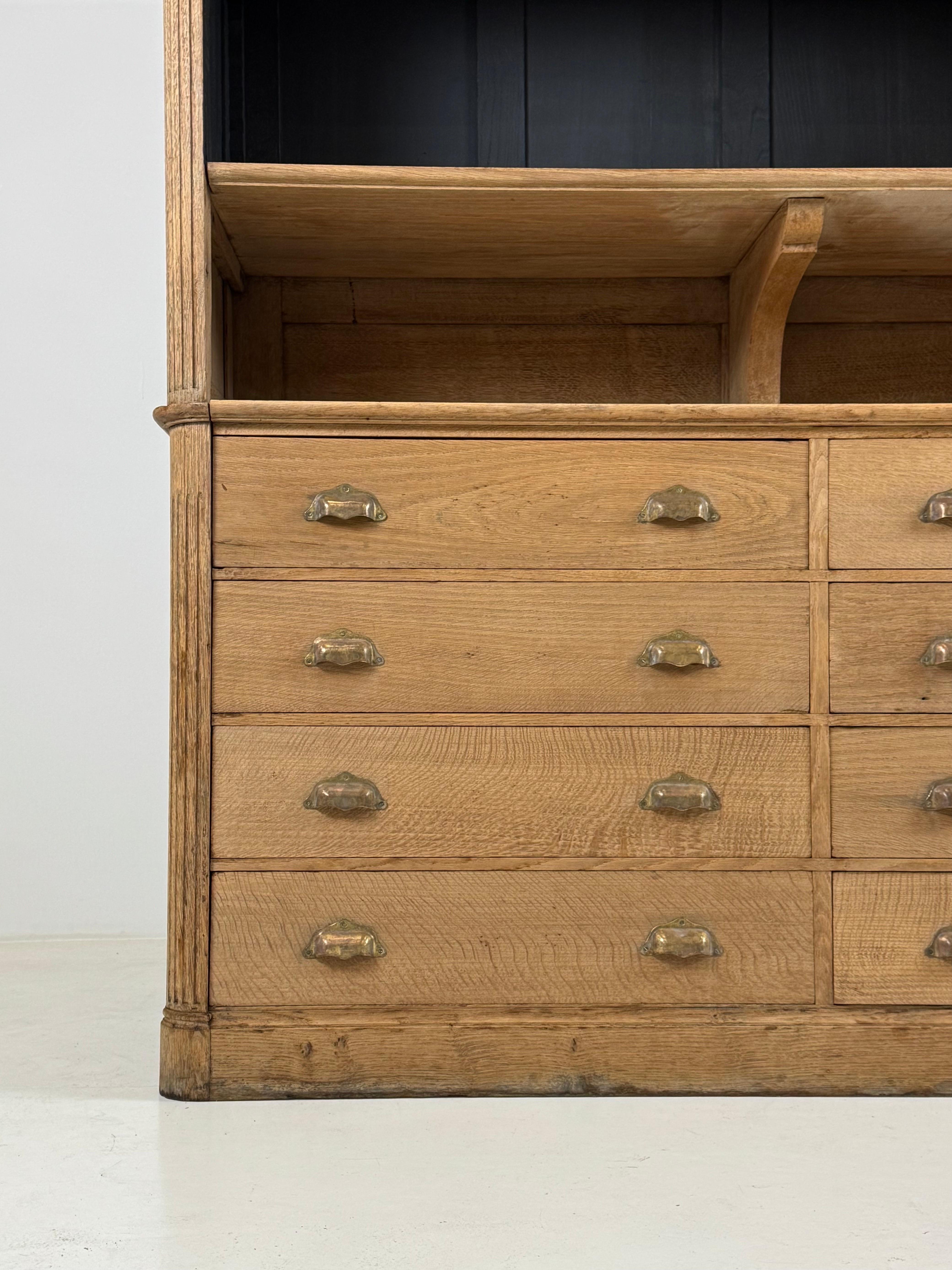 Country bookcase / sideboard / shop cupboard / library cupboard. Original from France, early 20th century. Washed solid oak. Has 8 good running drawers in lower part. Cupboard is in good condition!

Dimensions: W162 x H238.5 x D50
