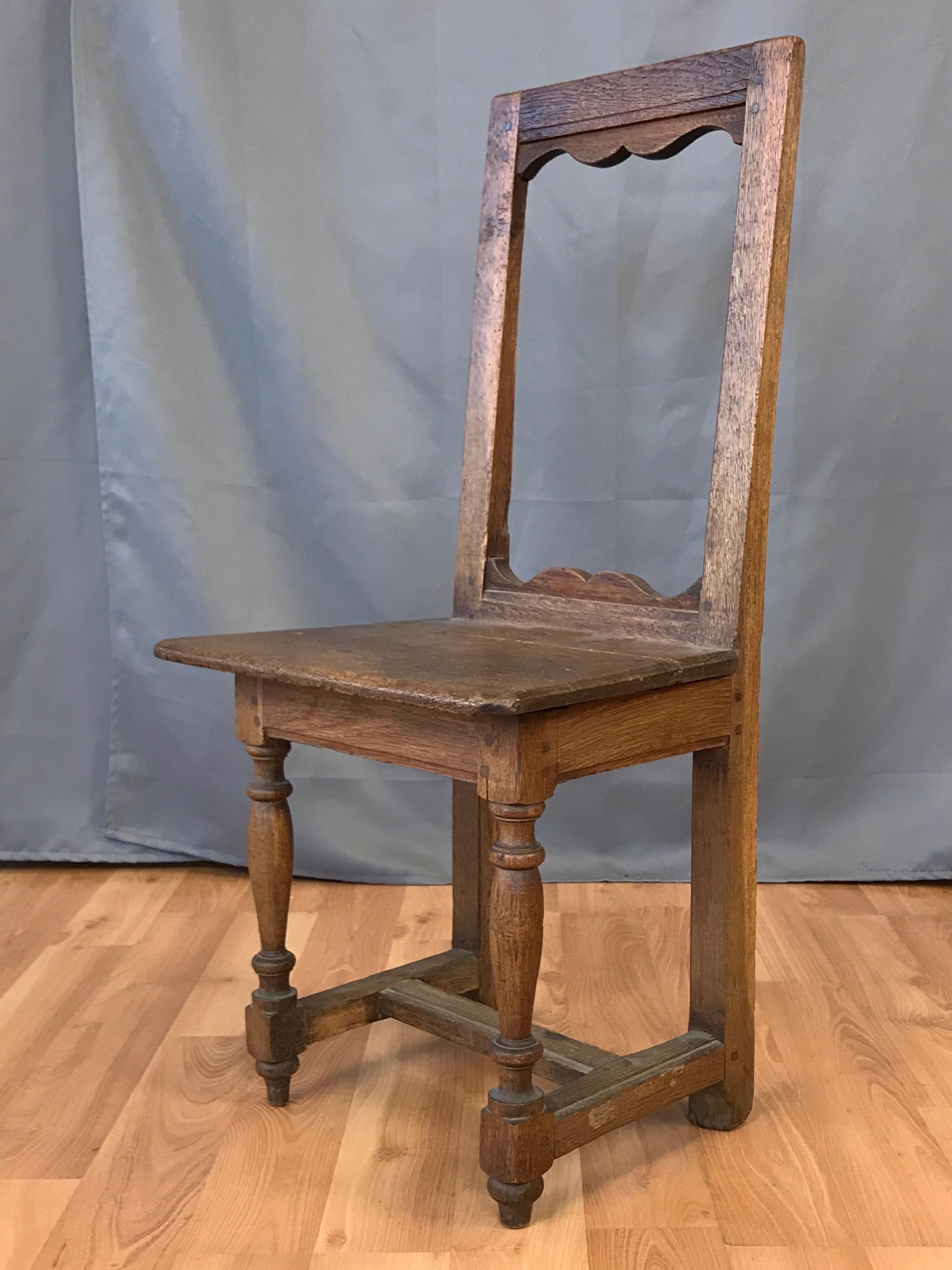 An uncommon 17th century French “nun’s” chair of handcrafted solid oak. Traditionally found in Catholic convents or monasteries, such chairs were designed to facilitate the act of praying, with the one offered here being a particularly fine and