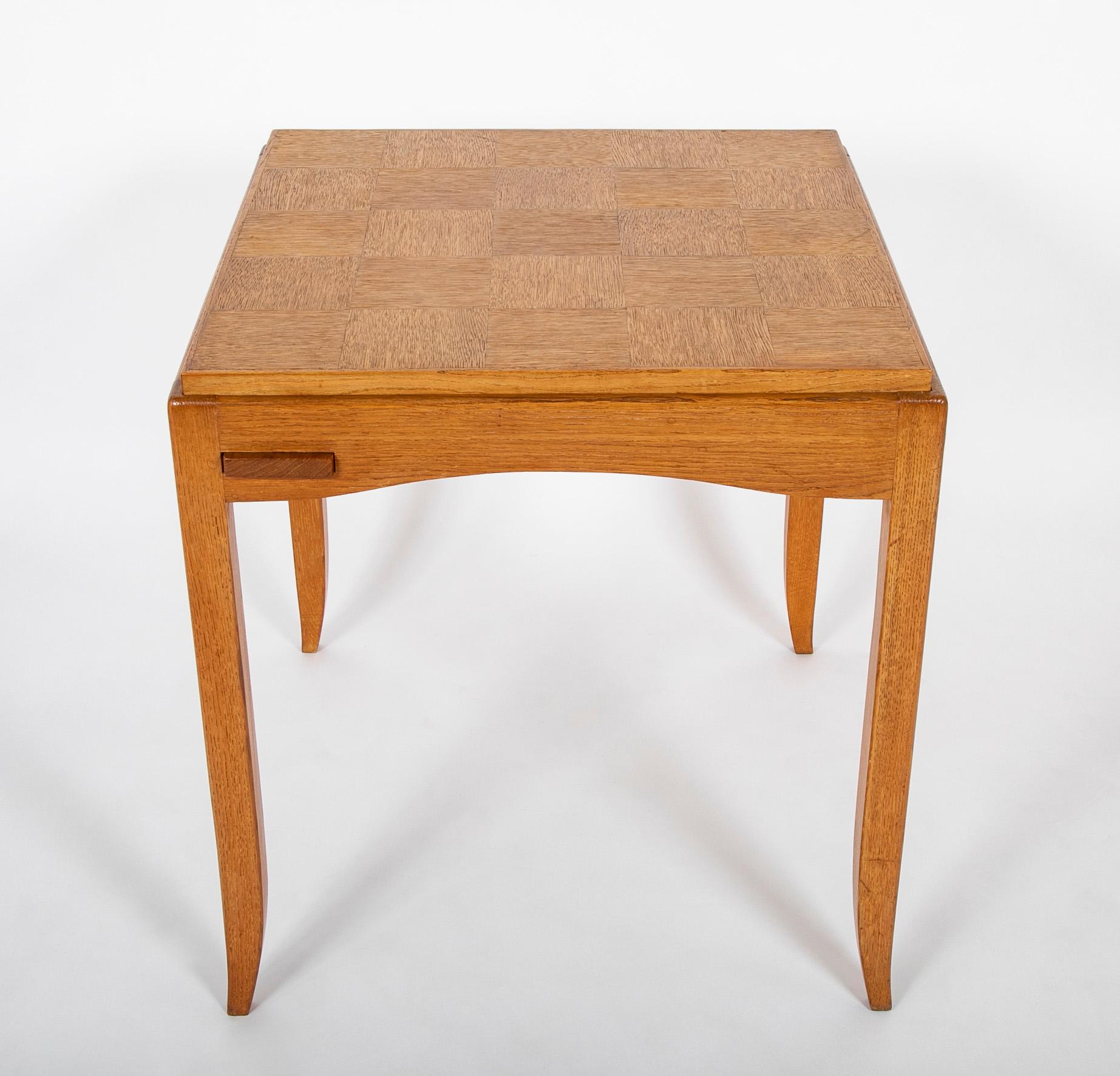 Oak games table with parquetry top, reversable to felt, ending on sabre legs designed by Victor Courtray ( French., 1896 - 1987 ).  Circa 1950's.