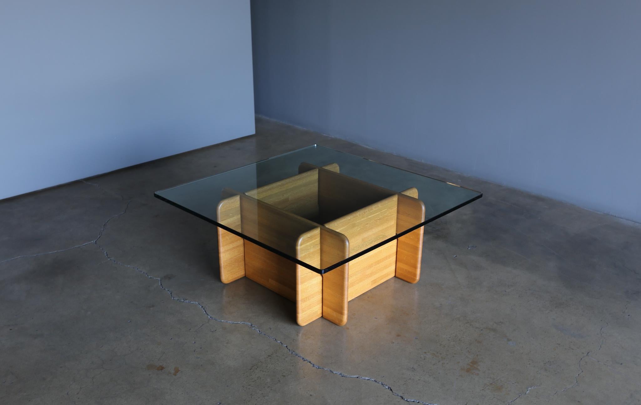 Solid oak and glass coffee table, circa 1975.
