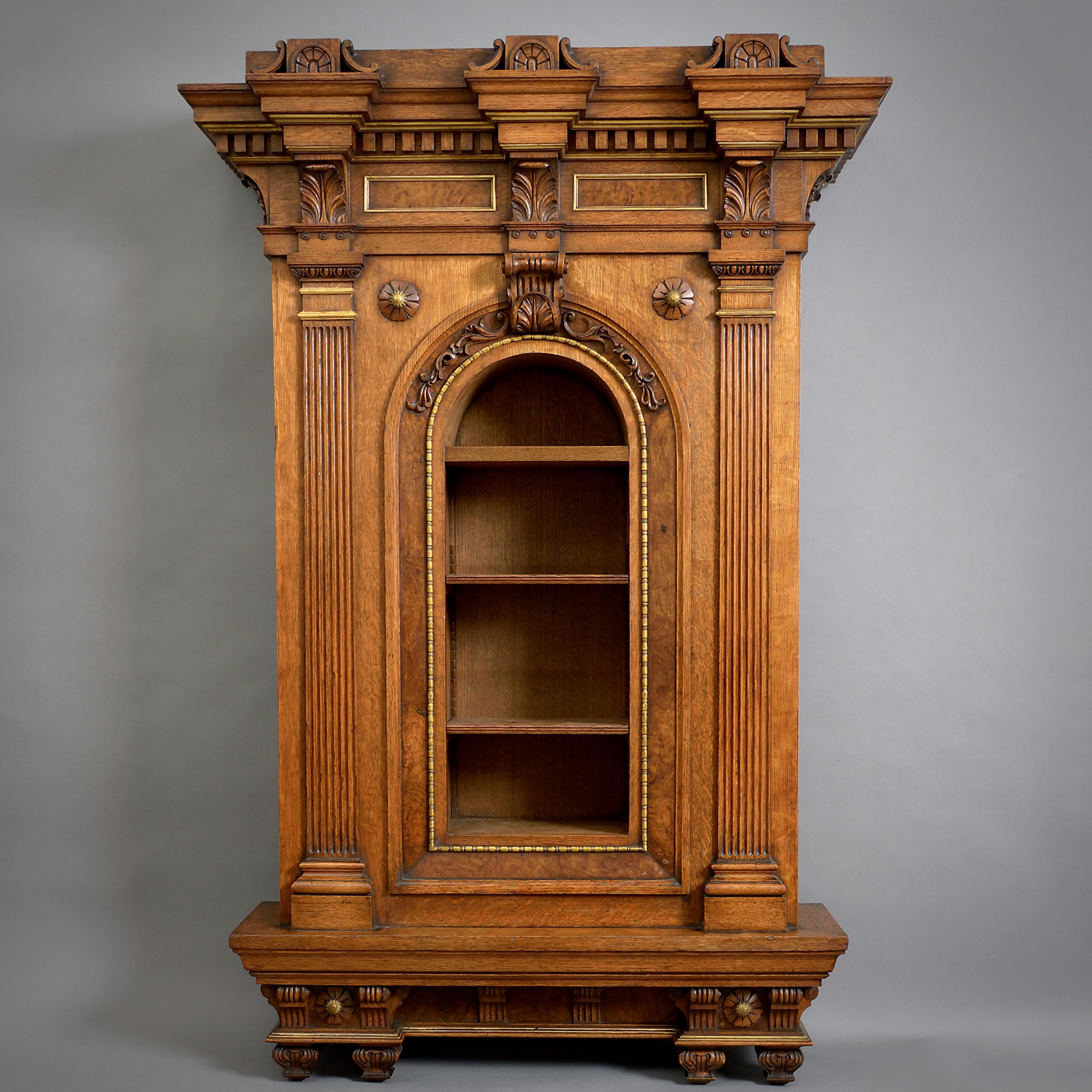 A MAGNIFICENT PARCEL-GILT OAK AND POLLARD OAK HANGING CABINET ATTRIBUTED TO ROBERT HUME, AFTER DESIGNS BY WILLIAM BECKFORD AND H. E. GOODRIDGE, Circa 1835.