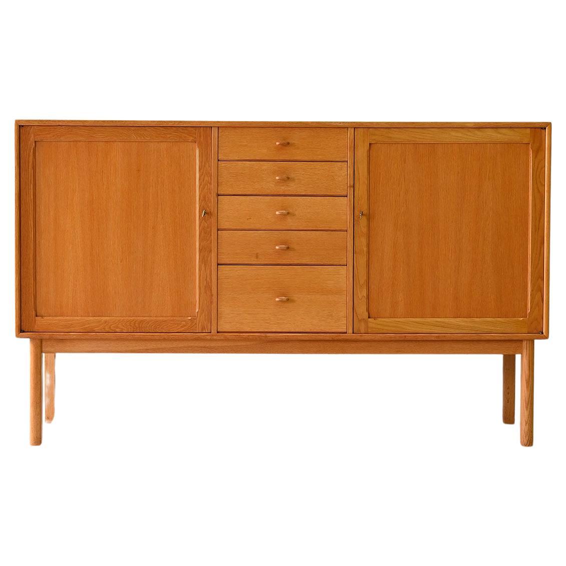 Oak highboard with center drawers For Sale