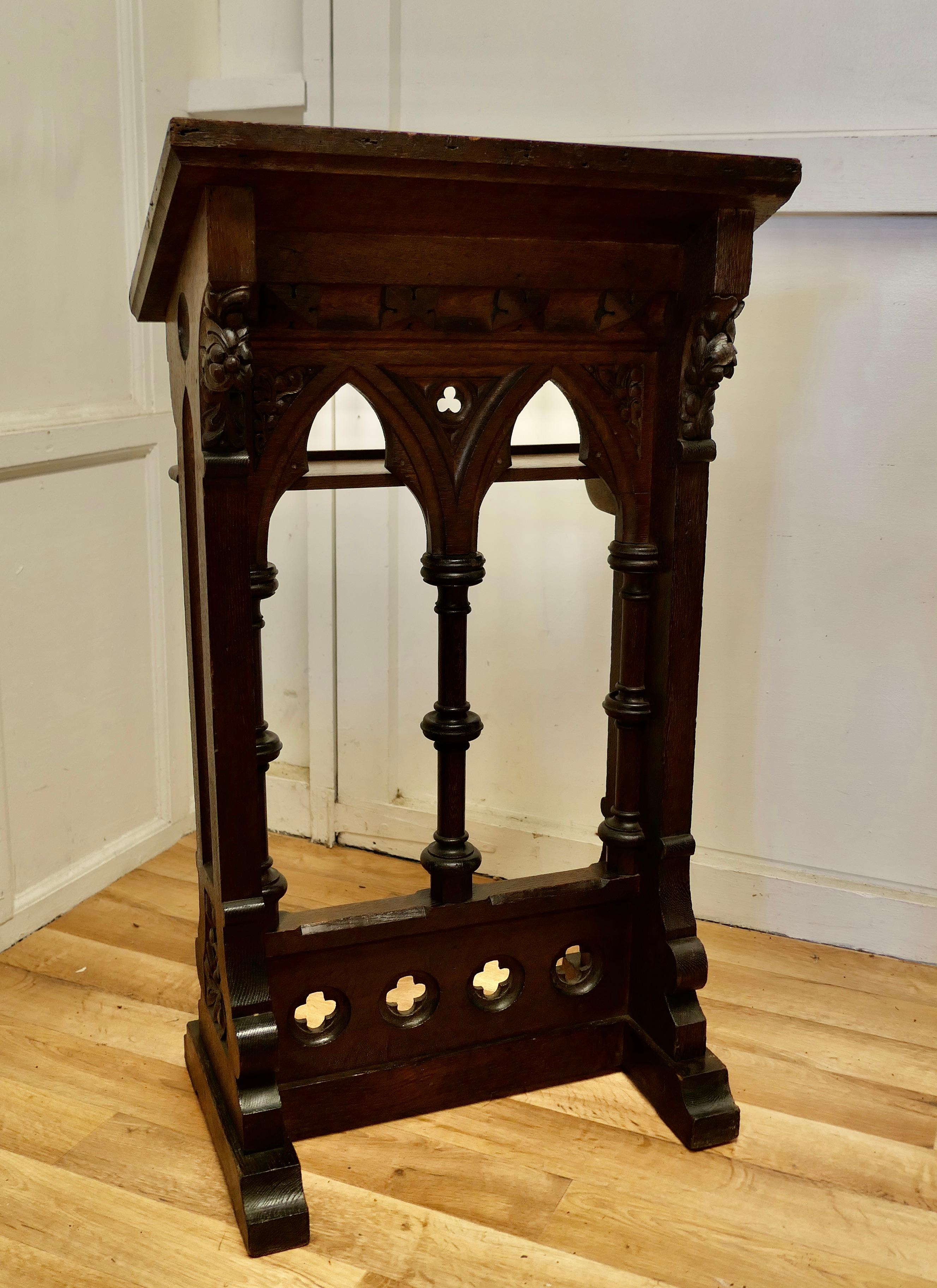 Oak hotel restaurant podium reception greeting station, greeter.

This one has a very Gothic Look, the sloping top has a rail to hold menus or similar from slipping off and there is a similar flat shelf below.
The Reception desk is in good