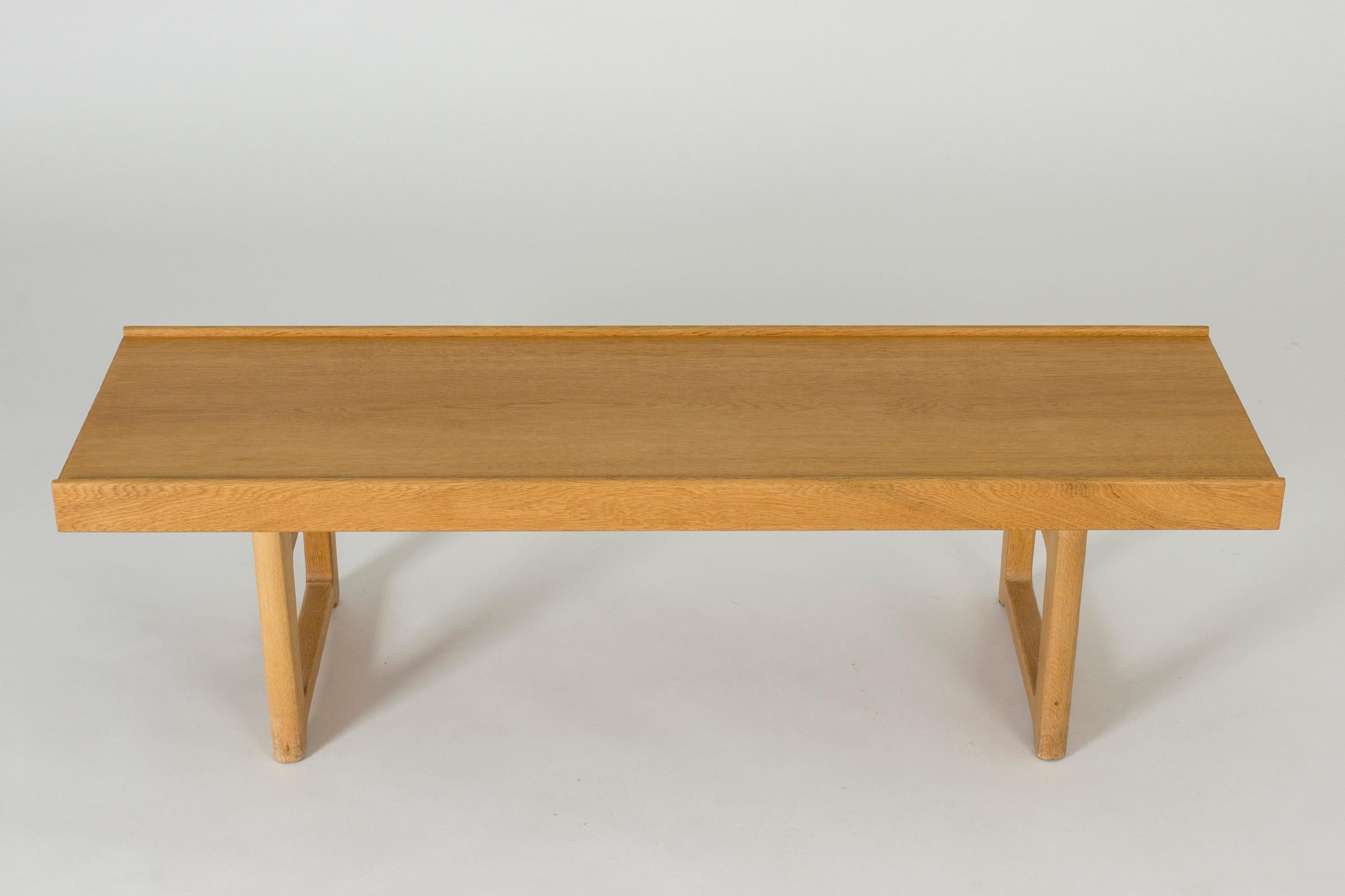 Neat, smaller size “Krobo” bench by Torbjørn Afdal. Made from oak with chunky legs and black metal extenders underneath as decorative details and stabilizers.