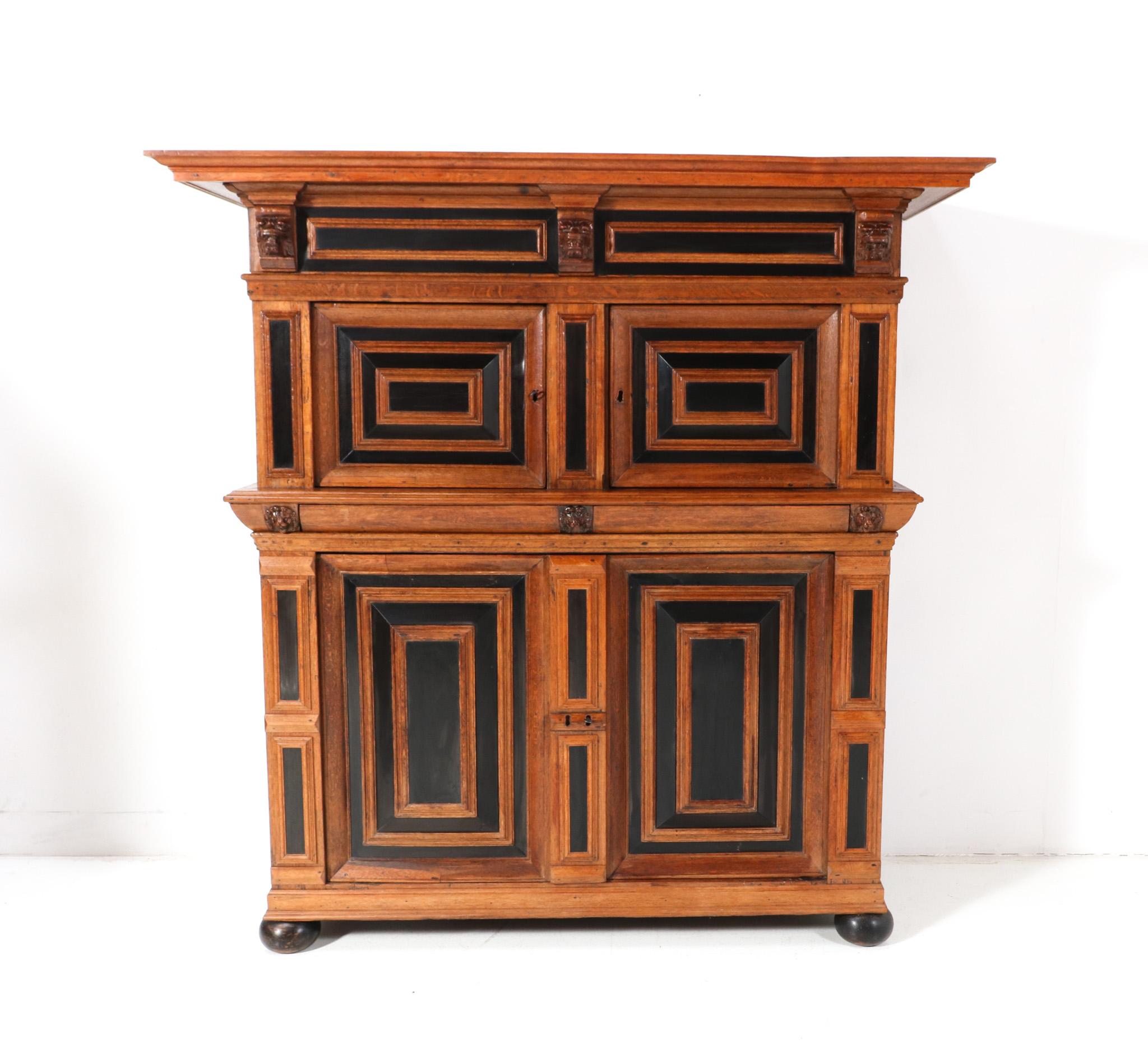 Stunning Renaissance cupboard or so-called Zeeuwse Kast in the Netherlands.
Striking Dutch design from the Late 17th century.
Solid original oak two-piece cupboard with original ebony elements.
The hand carved lion heads are also original.
This