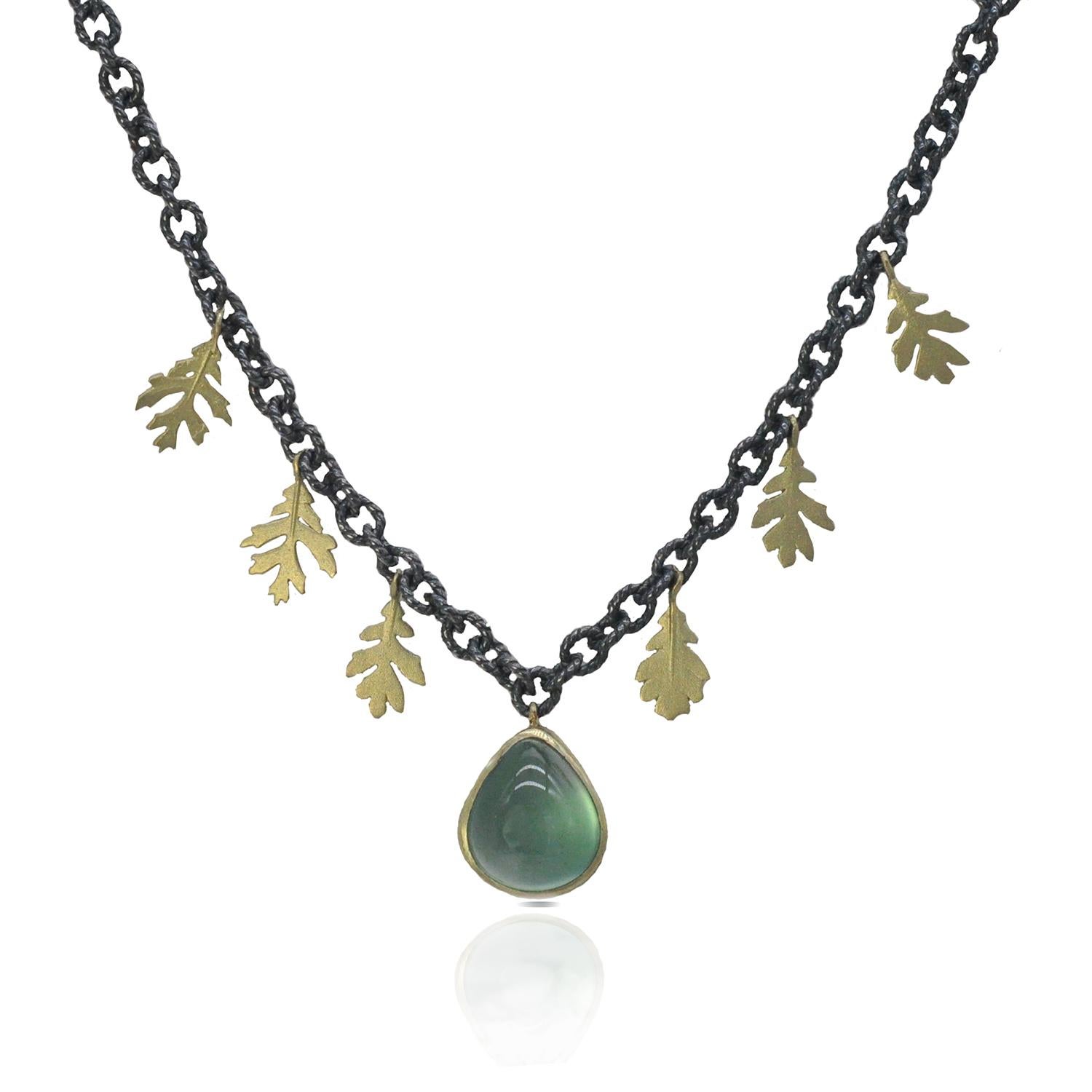 A sweet burst of soft leaf green glows in this version of our oak leaf necklace. A beautiful pear shaped prehnite sits between 18k yellow gold leaves that flutter along an oxidized silver chain for an elevated, bohemian style. The prehnite is 1/2
