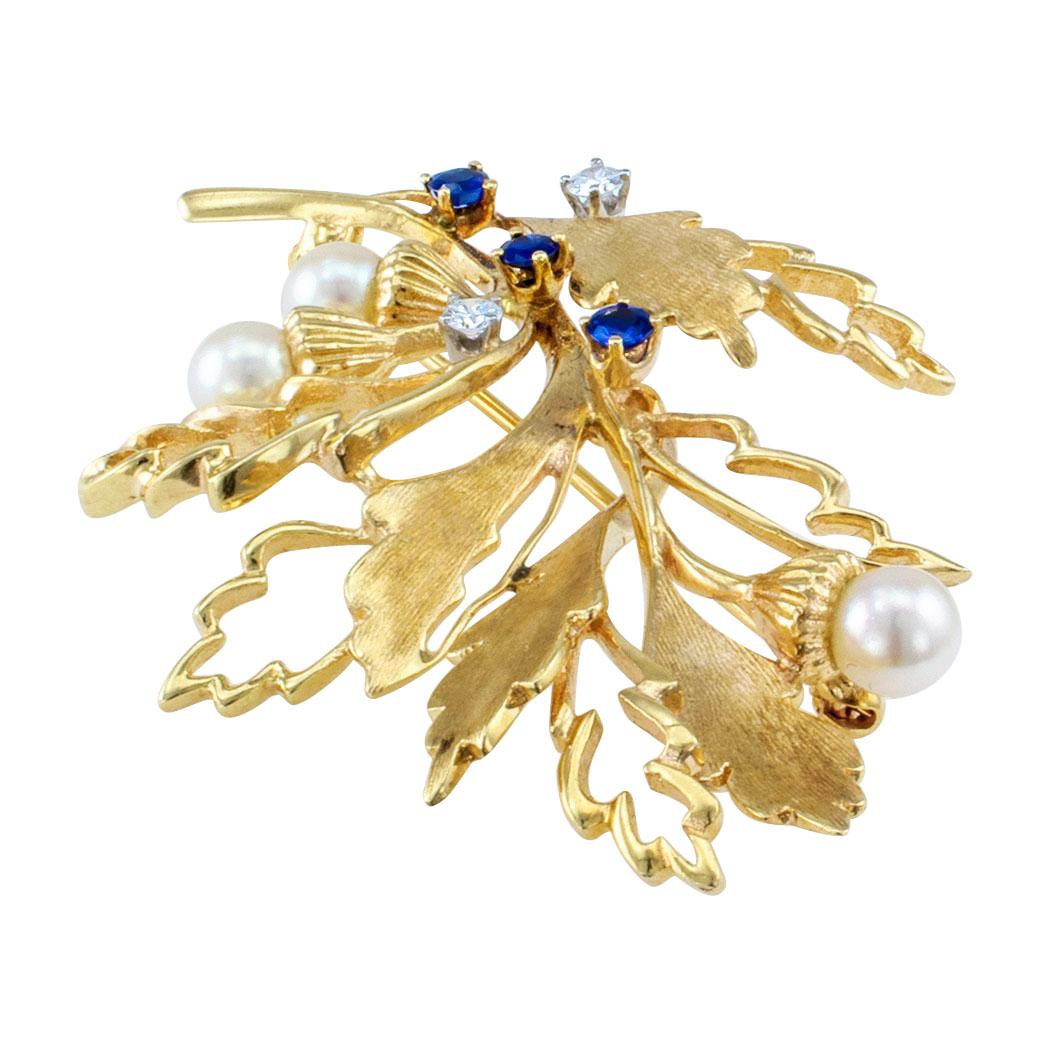 Estate 1960s cultured pearl diamond and sapphire oak leaf gold brooch. Designed as an oak leaf branch, alternating negative and positive spaces define the shapes of the leaves with acorns budding into cultured pearls, randomly sprinkled with three