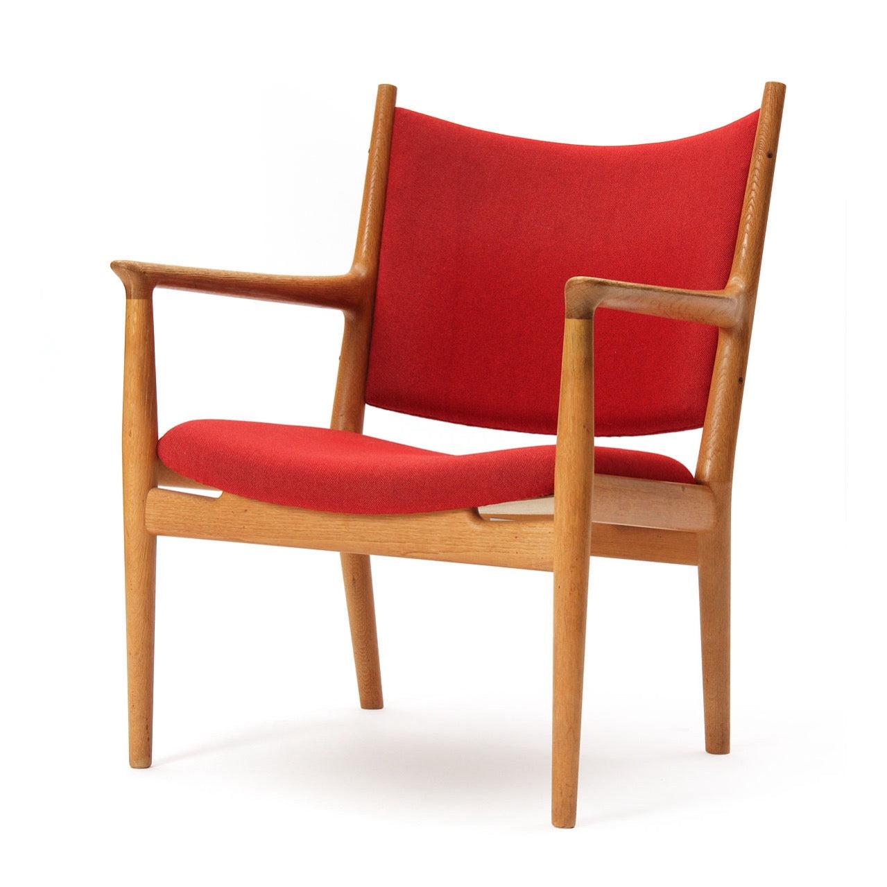 An oak lounge chair of generous scale having a solid wood frame and retaining the original wool upholstery.