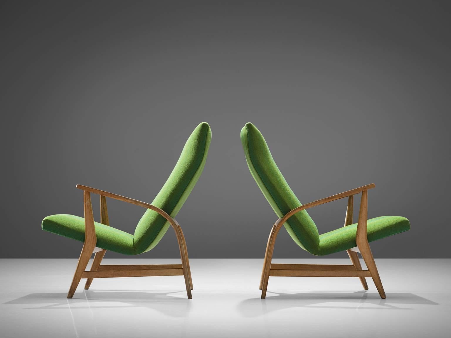 Easy chairs in green fabric and oak, France, circa 1955.

These lounge chairs, executed in beech and green fabric have backrests that are slightly tilted in order to provide the sitter with maximum comfort and frames. The seat is angular yet