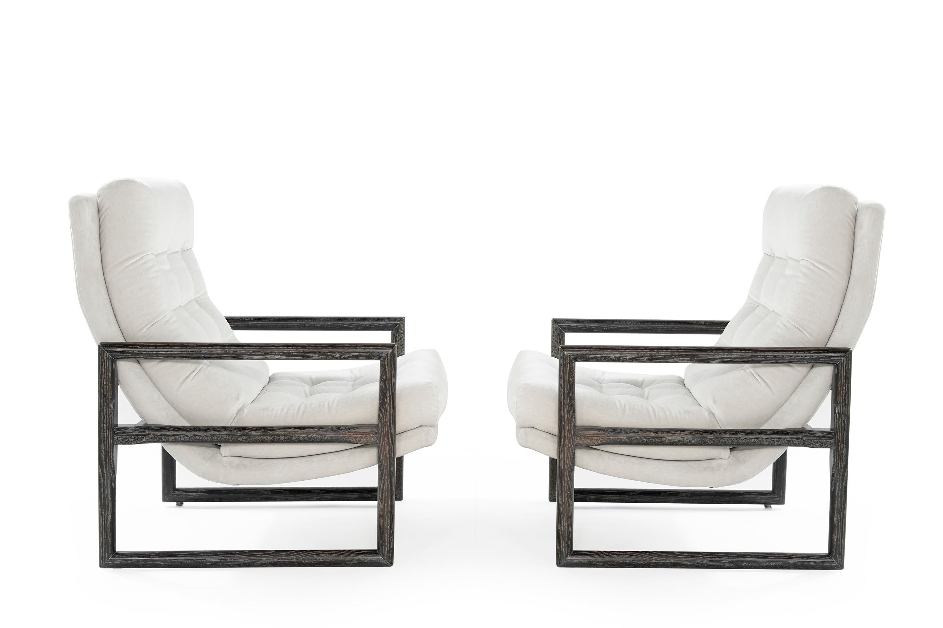 Pair of sculptural lounge chairs featuring newly cerused oak fames re-upholstered in light grey velvet by Holly Hunt.