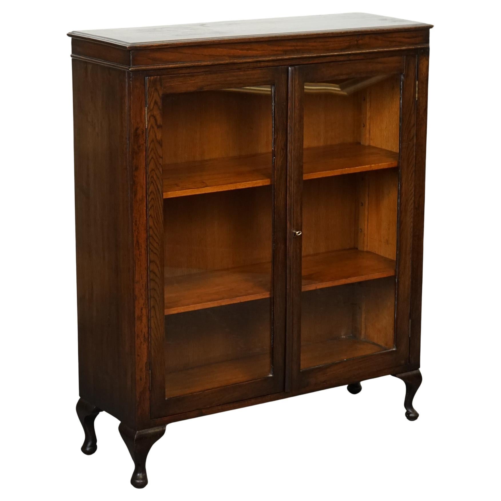 OAK LOW BOOKCASE WITH GLAZED DOORS ADJUSTABLE SHELVES AND CABRIOLE LEGS j1 For Sale
