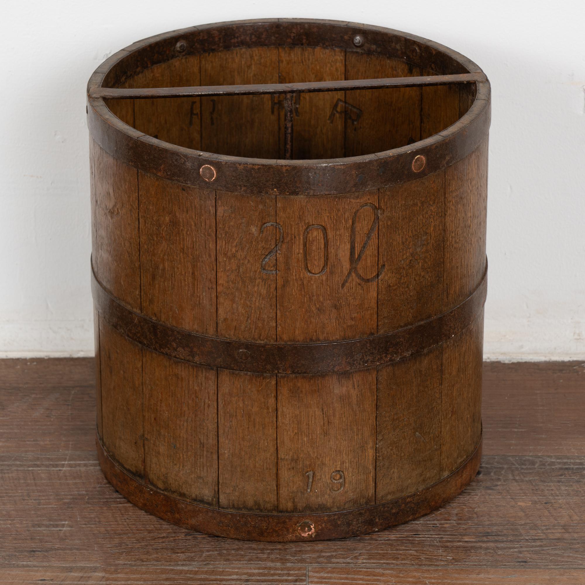 20 liter old oak measuring bucket with iron banding. 
Iron cross bar and central rod that connects cross bar to bottom of bucket interior. 
In stable, waxed condition.
Any scratches, cracks, dings, or age related separation are reflective of age and