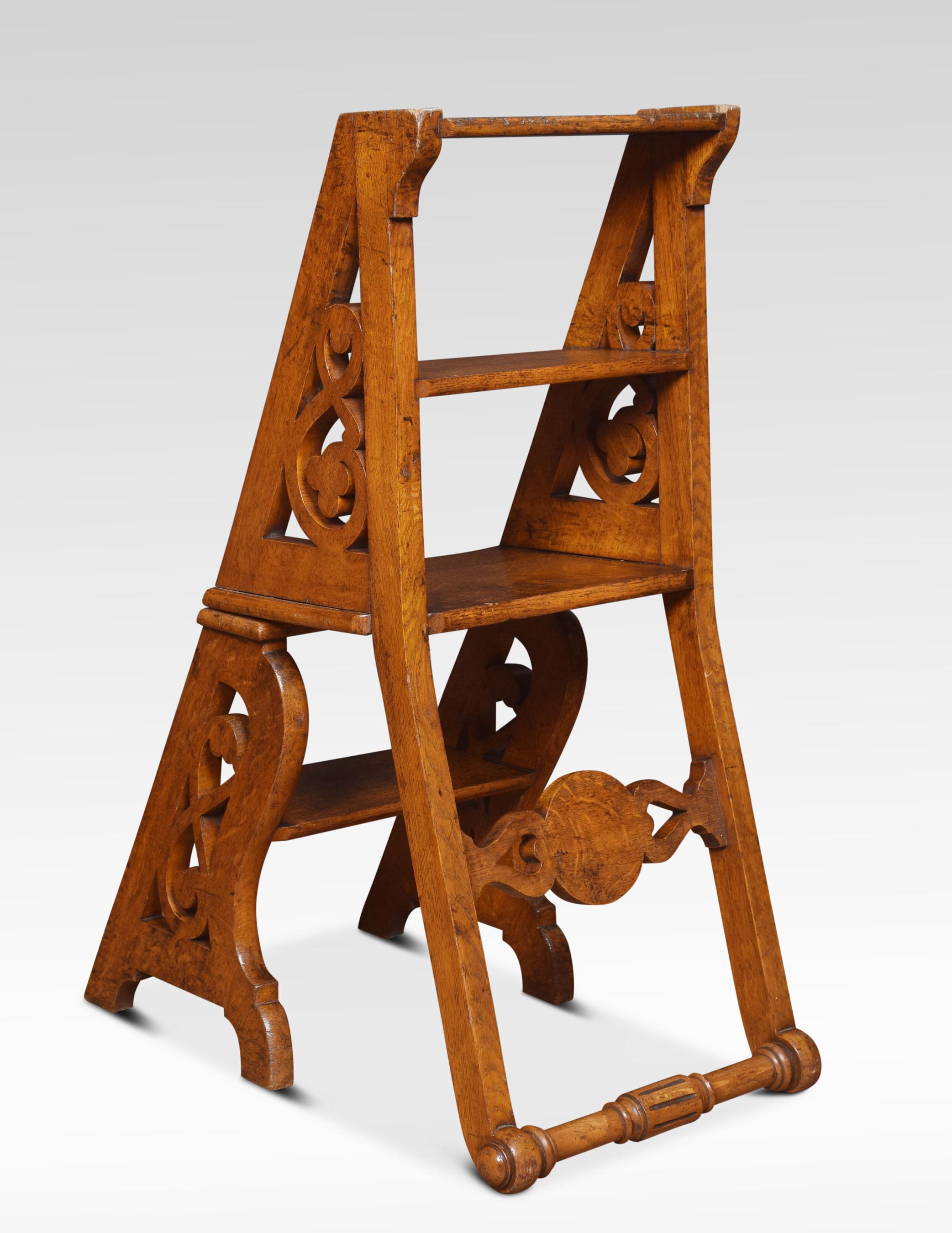 Oak metamorphic library steps/chair, the carved centre rail inscribed with initials K.J with a solid oak seat above pierced scroll supports with foliate decoration. The chair opens into a sturdy set of Library steps.
Dimensions
Height 35.5