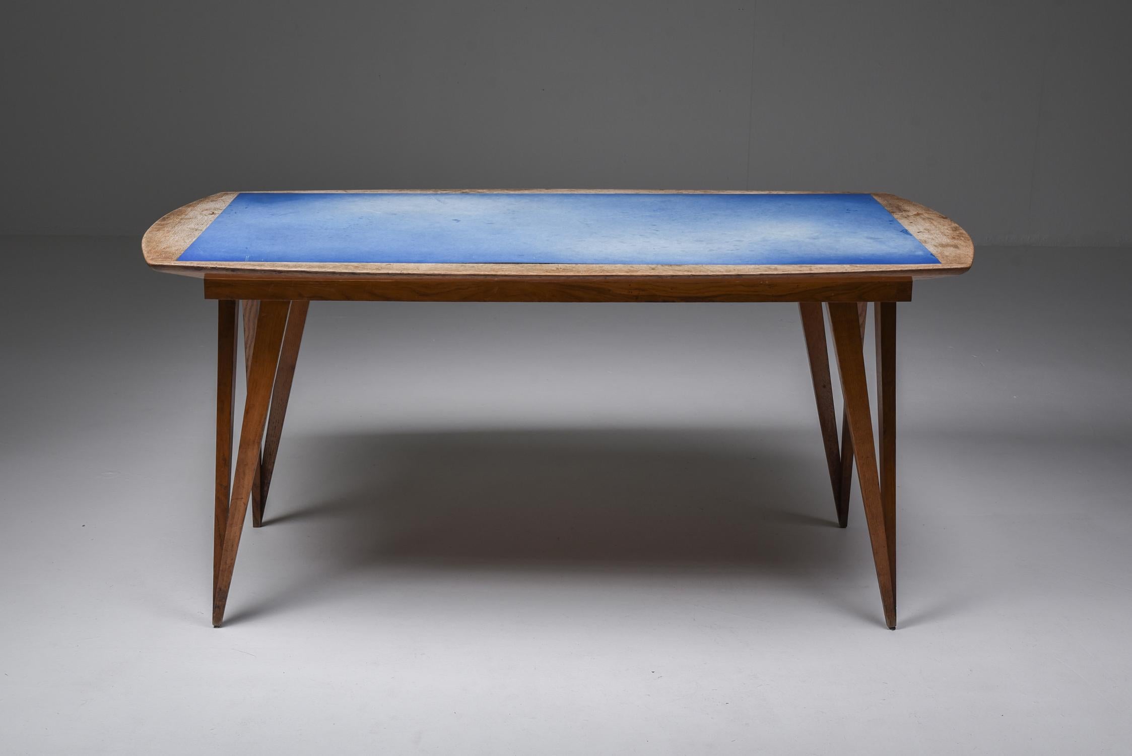 Early Mid-Century Modern dining table, solid oak, blue Formica top, Italy, 1940s

Unusual dining table from the 1940s on pin legs with a blue Formica top in original condition.

The legs and frame are solid oak, which have gained an unmatched