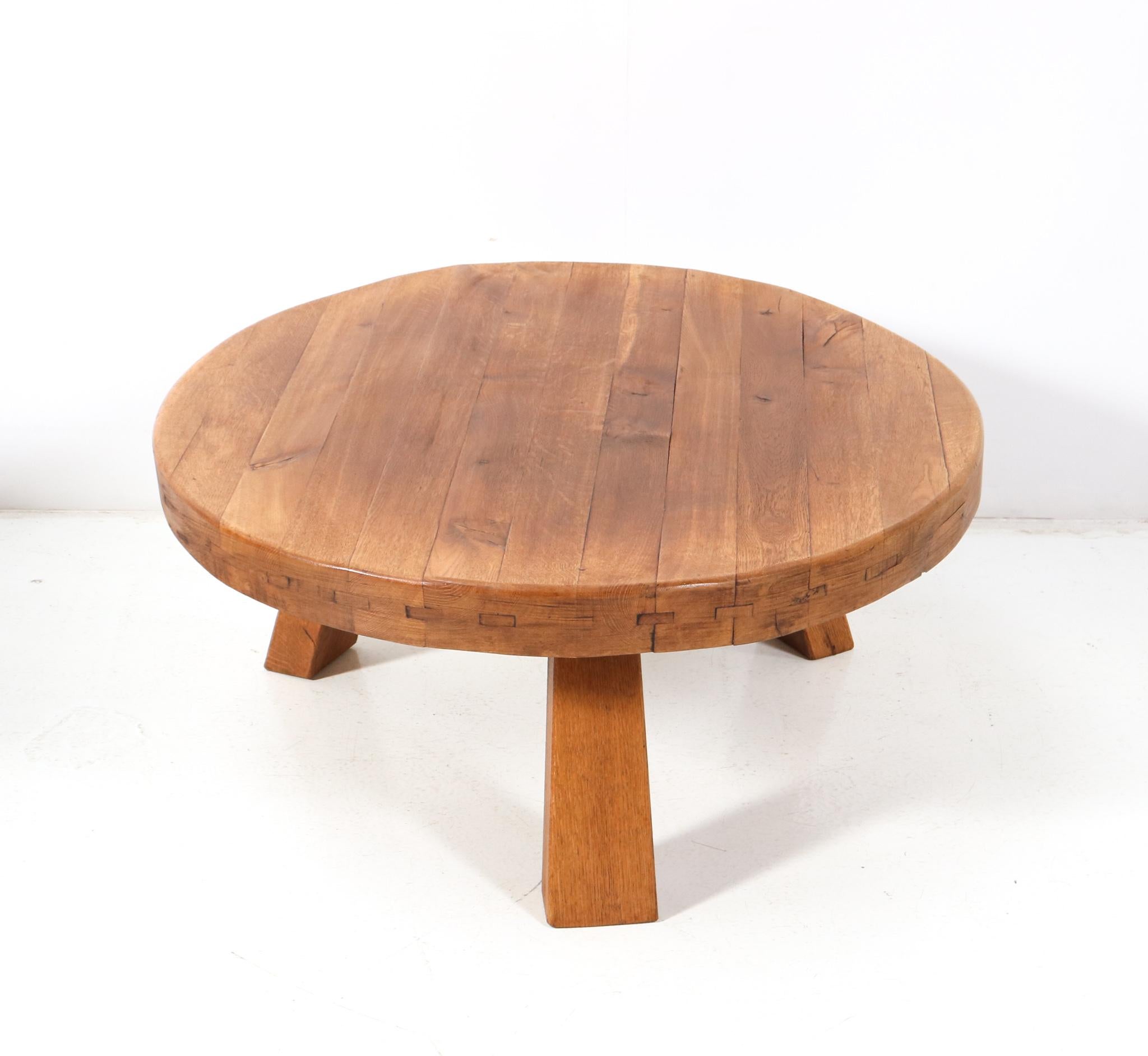 Stunning Mid-Century Modern Rustic Brutalist round coffee table.
Striking Dutch design from the 1960s.
Solid oak top on three solid oak legs.
This wonderful Mid-century Modern Rustic Brutalist round coffee table is in very good condition with