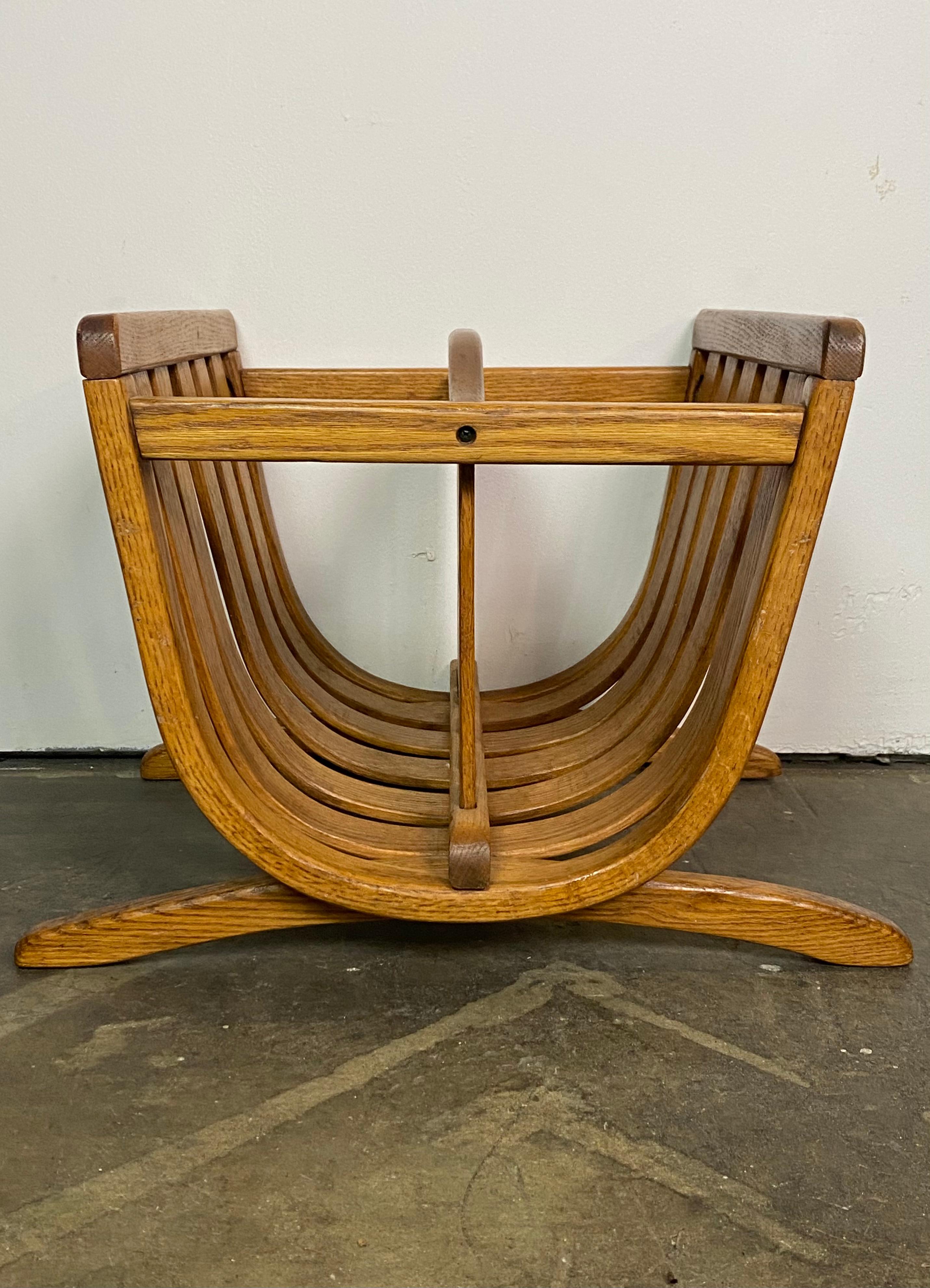 Oak Mid-Century Modern magazine rack. Sold and sturdy with great patina and elegant lines. Handsome wood grain and even color. Cleaned and oiled.