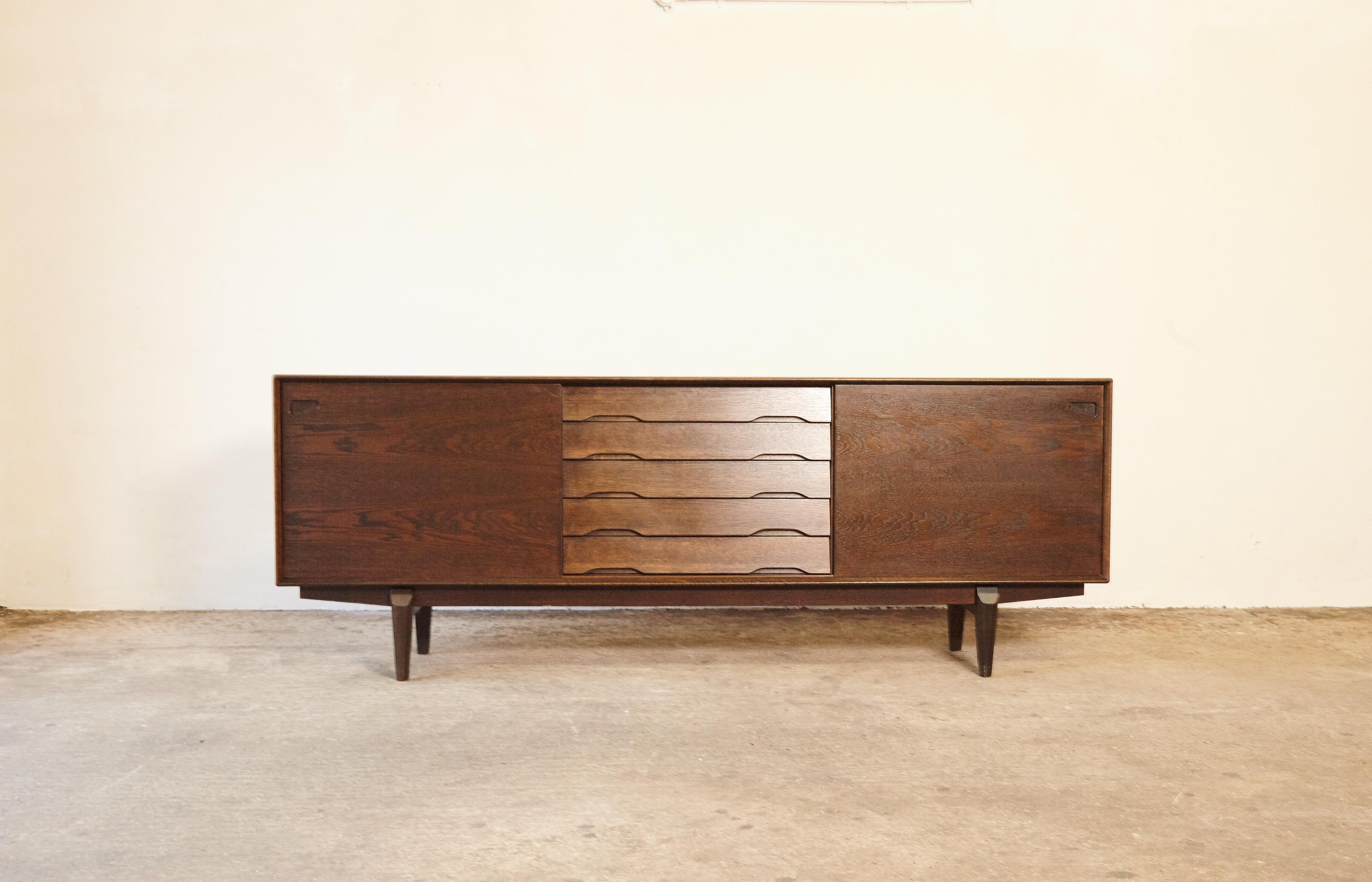Beautiful Danish midcentury No. 65 sideboard by Skovby Mobler. In stained oak, with five drawers and two sliding door on the front and the inside with shelves. More photos coming soon. Ships worldwide - please contact us directly for a