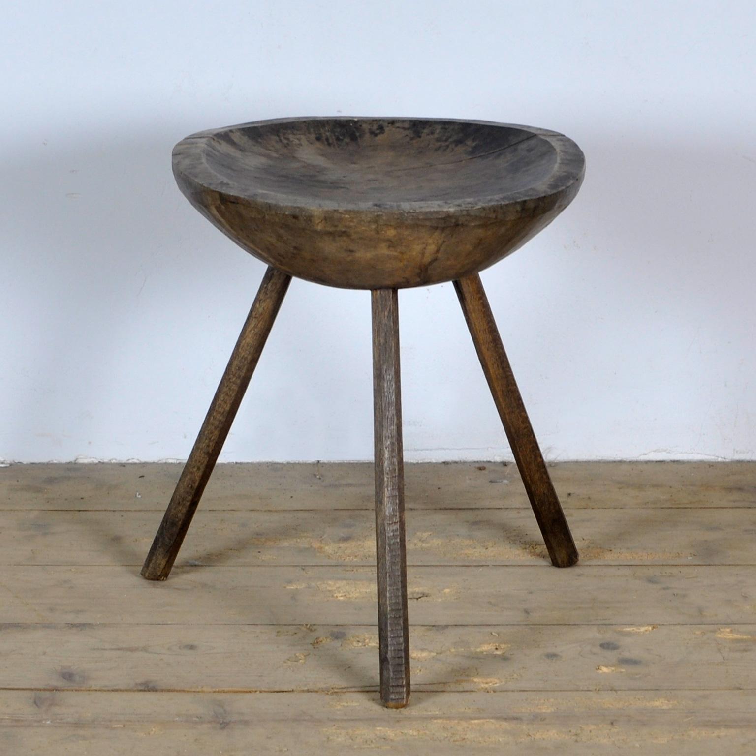 Original handmade folk art milking stool. Made in France, late 19th century. Solid oak stool with tripods so that the stool is never unstable. Simple in design, with a hollowed out seat.