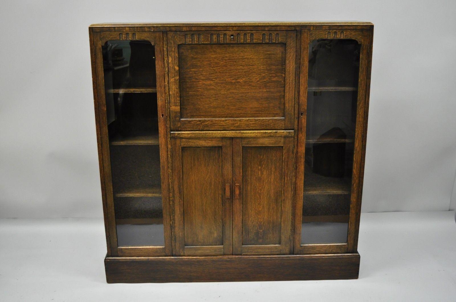 Antique oak Arts & Crafts drop front secretary desk bookcase by Goodalls. Item features solid wood construction, beautiful wood grain, original label, working lock & key for desk, side doors unlocked and does not include key. circa early 20th