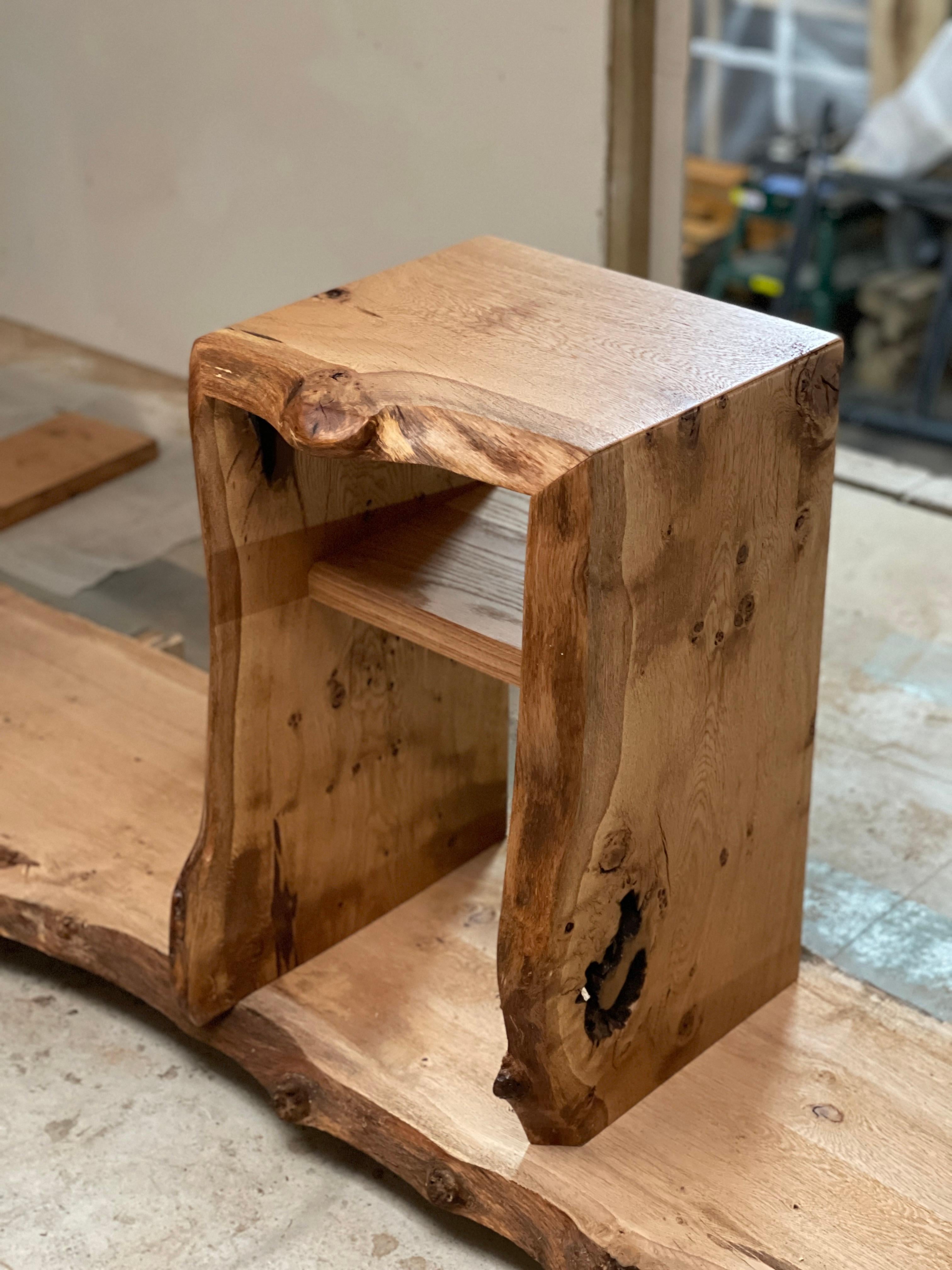 Oak bedside table / nightstand.

Made from one single slab of waney edge / live edge oak, the slab is cut into three pieces and re-joined at 45 degree angles to achieve the waterfall effect in which the grain falls from one side to the next with the
