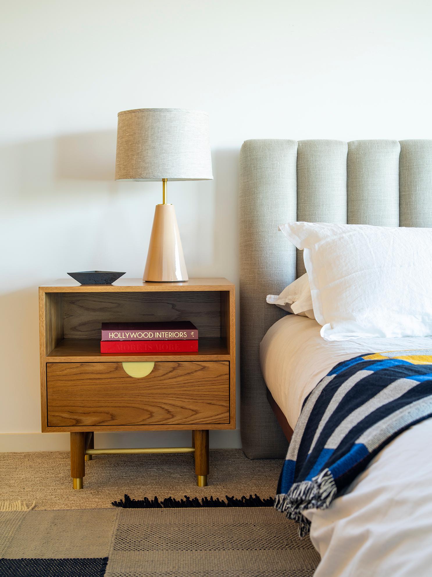 The Niguel side table features one drawer and an open shelf. Details include leveling brass cap feet, a brass stretcher on the base, lacquered interior and inset brass hardware. Available in American walnut or white oak. 

The Lawson-Fenning