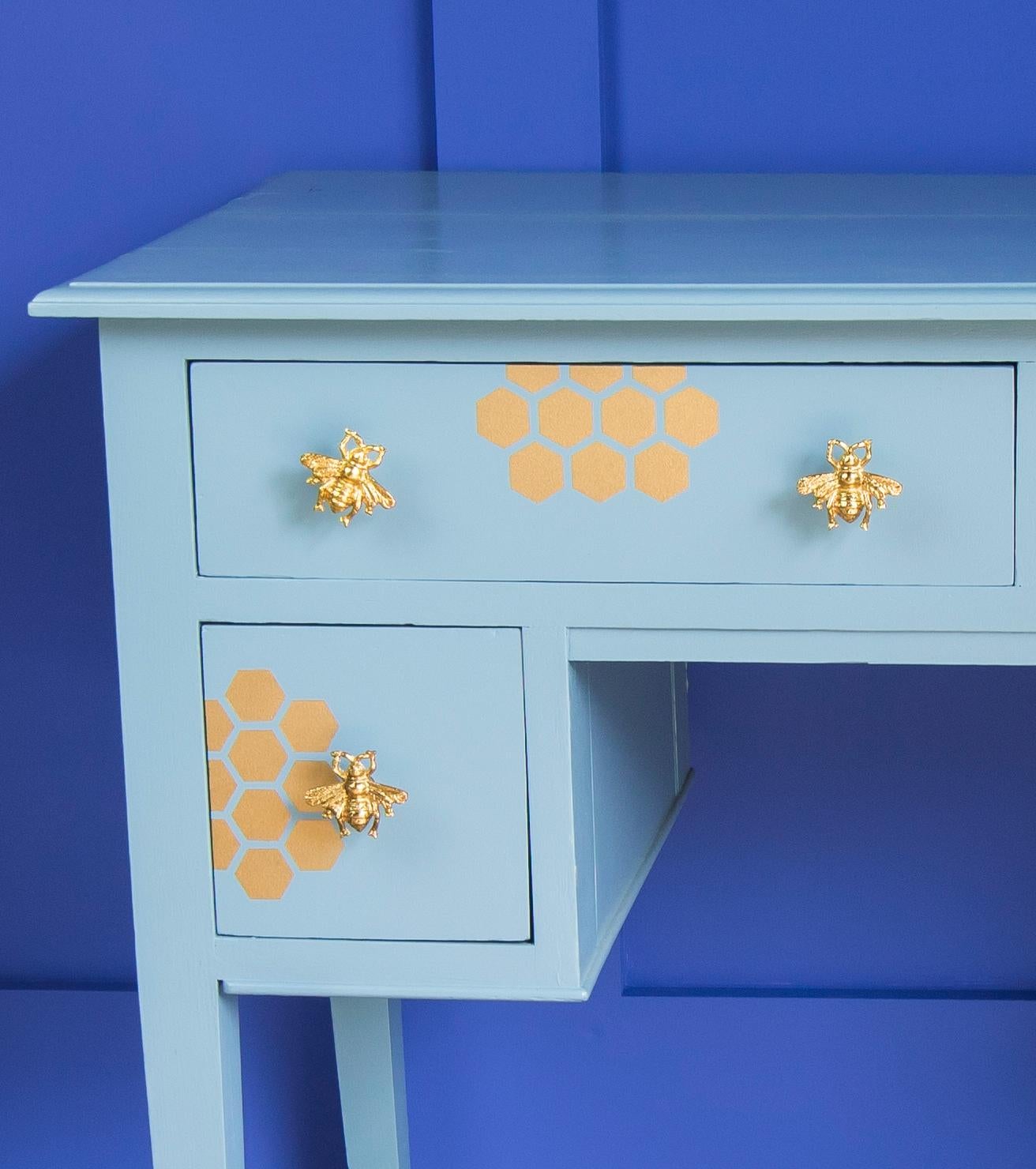 Small but perfectly formed oak painted desk in blues and golds. Bumble bee gold metal handles and gold dipped legs. This was a 'bonfire' find and has had a lot of painstaking work! Solid Oak and ready to serve another lifetime!

Desk or dressing