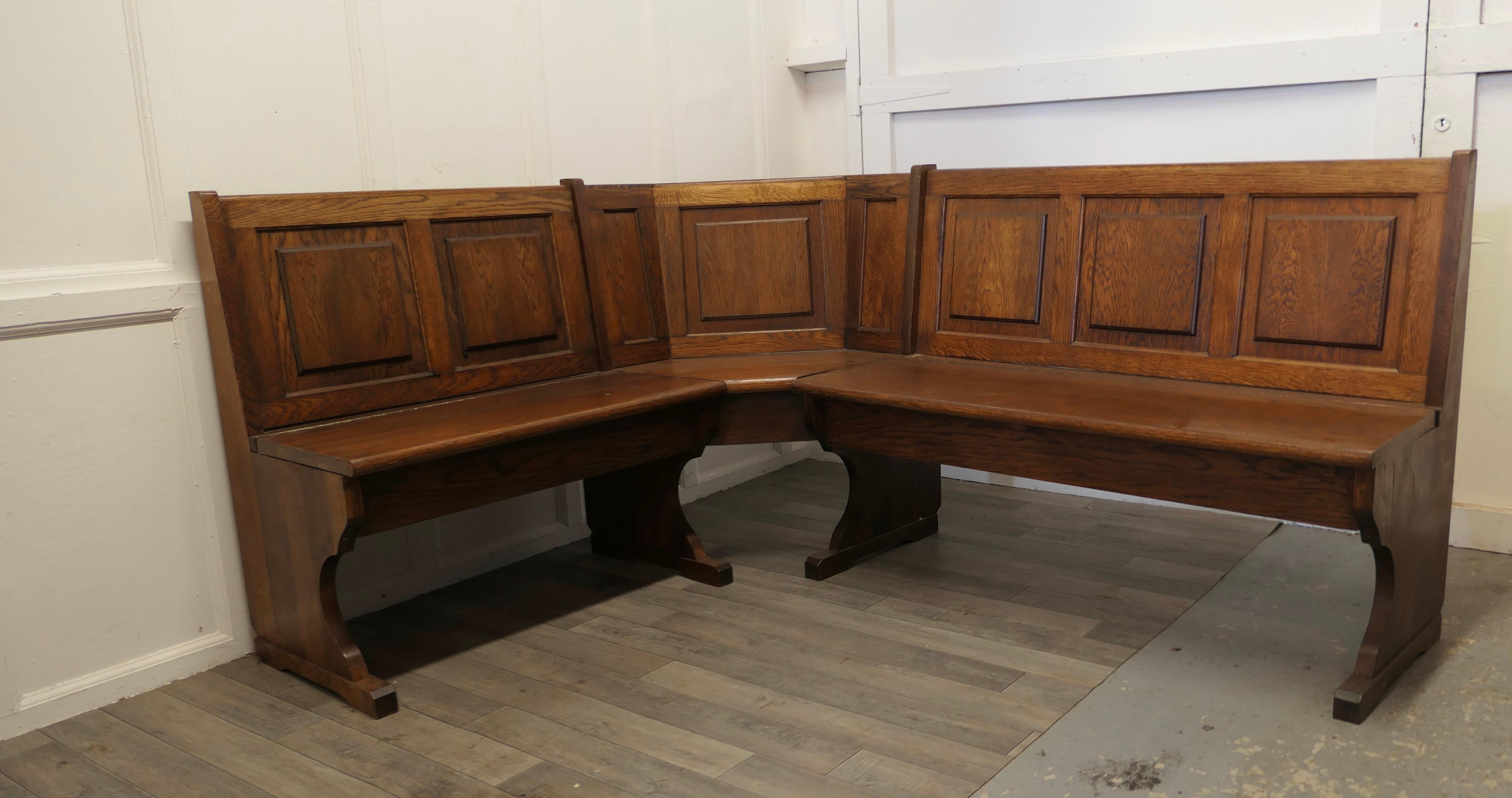 Oak Panelled pub corner settle or kitchen bench

This is a great looking piece in medium colored Oak, it has a three panelled bench seat at one side and a similar two seater at the other, with a corner unit between, the set is dismantle-able for